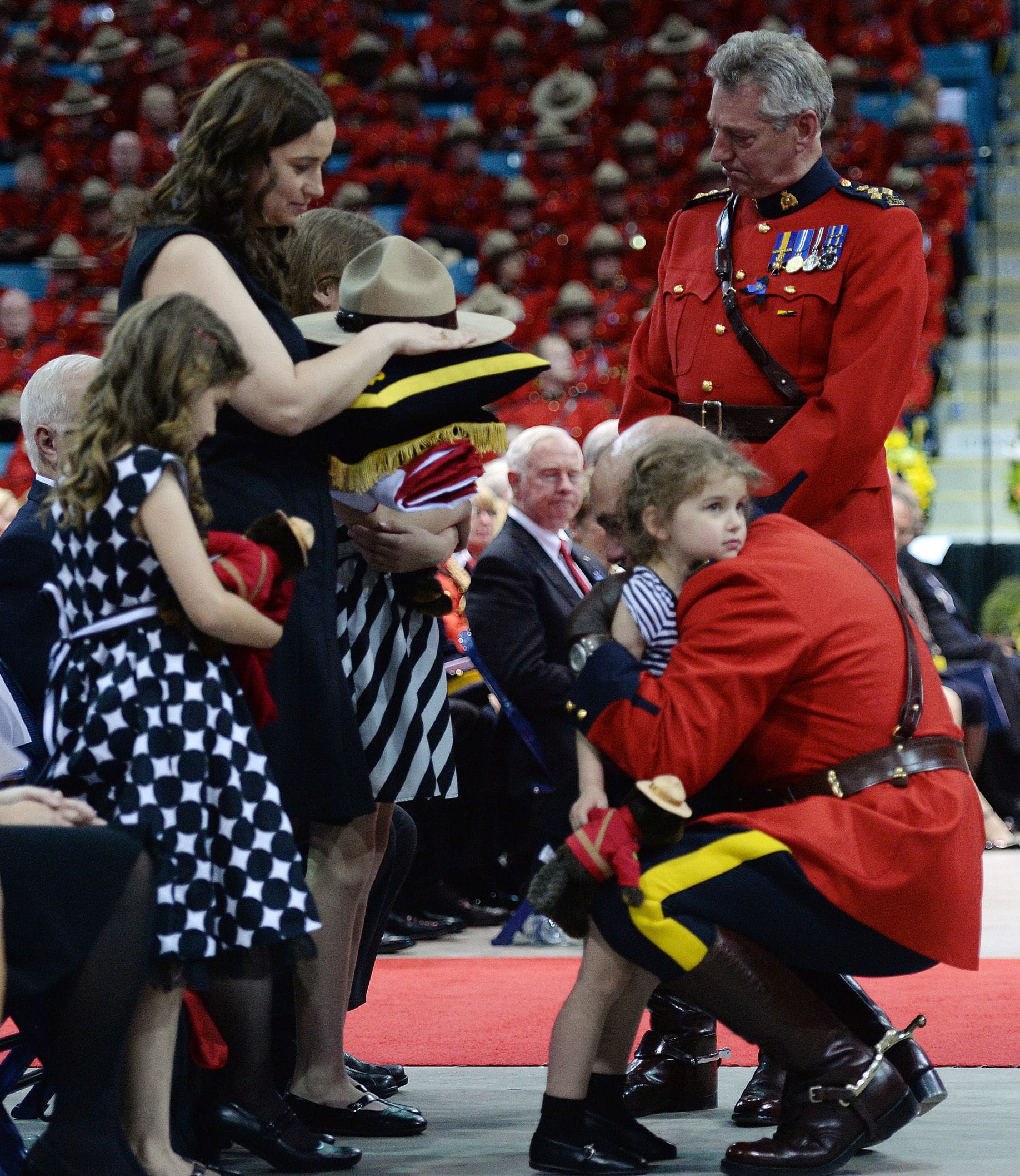 Royal Canadian Mounted Police Commissioner Bob Paulson hugs Const.