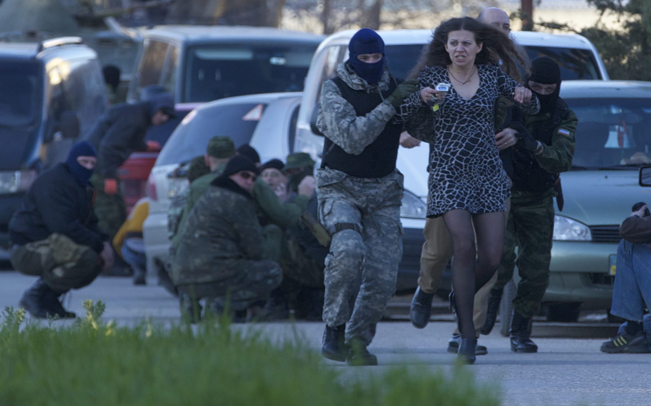Pro-Russian militia members evacuate a local resident as Russian troops assault the Belbek air base, outside Sevastopol, Crimea, on Saturday.