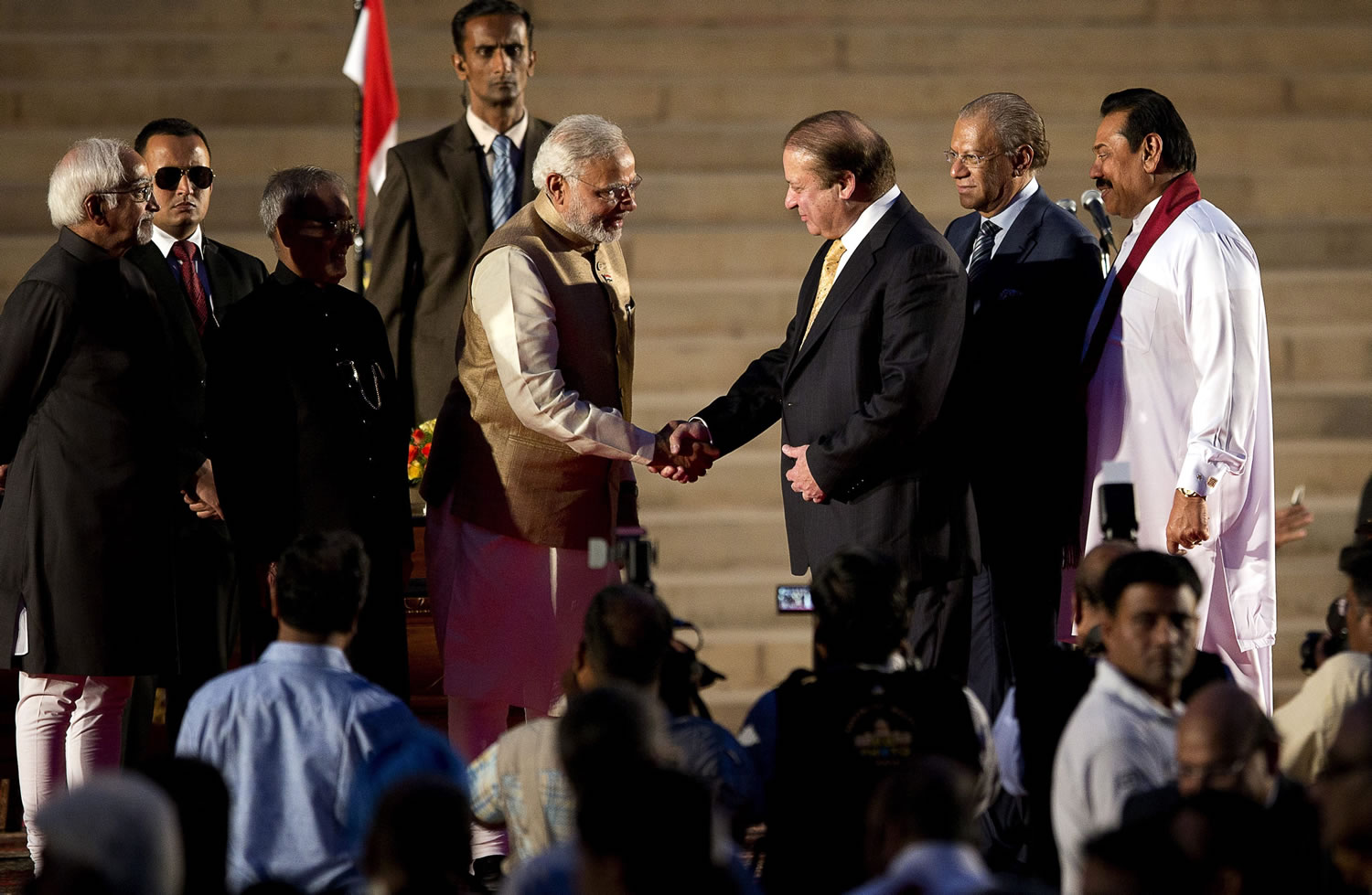 India's new prime minister Narendra Modi, center left, shakes hands with his Pakistani counterpart Nawaz Sharif, as Sri Lankan President Mahinda Rajapaksa, right, and Mauritius Prime Minister Navinchandra Ramgoolam, second right watch during Modiis inauguration in New Delhi, India, on Monday.
