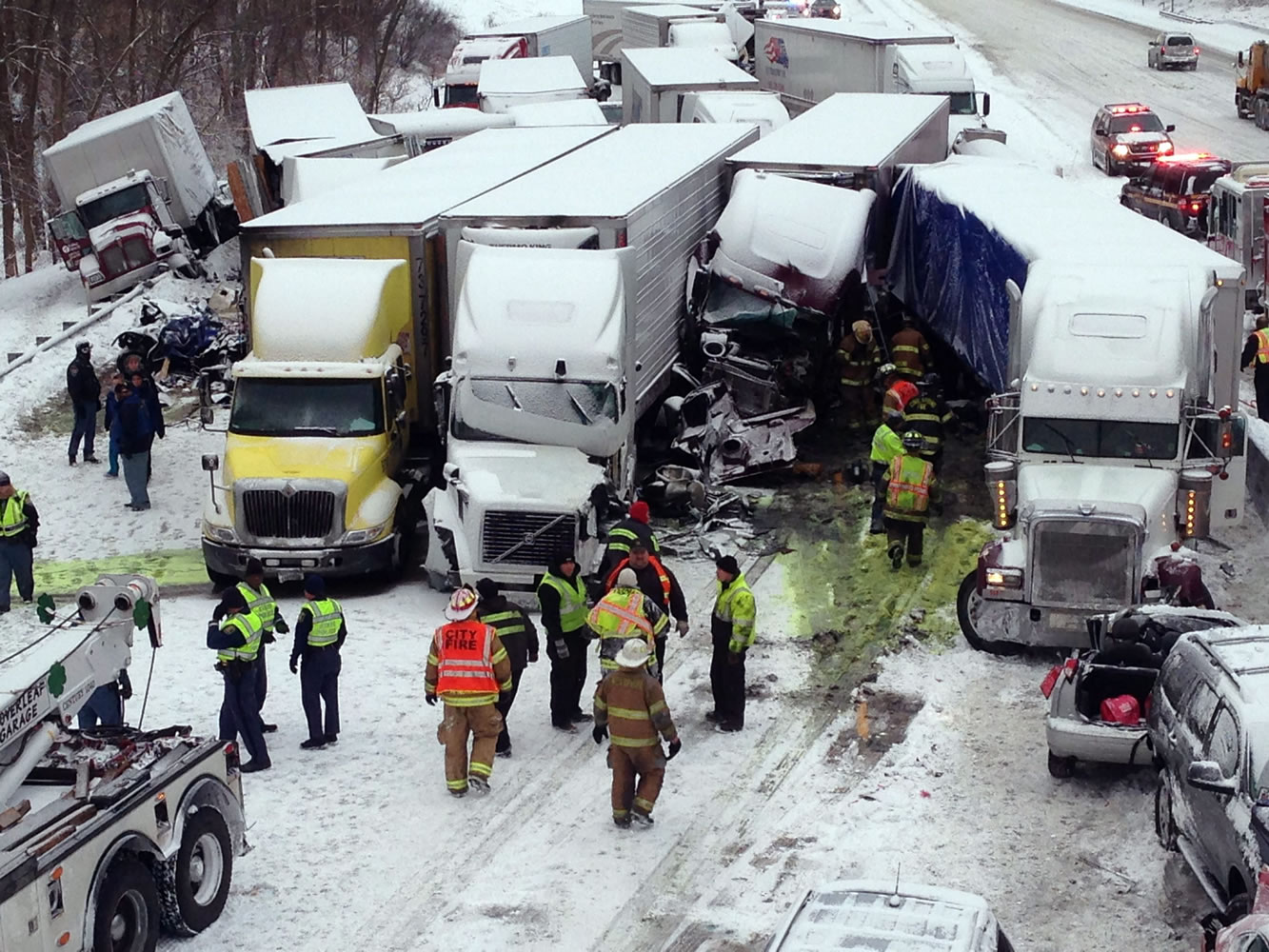 Emergency crews work Thursday afternoon at a massive pileup involving more than 40 vehicles, many of them semitrailers, on Interstate 94 near Michigan City, Ind.