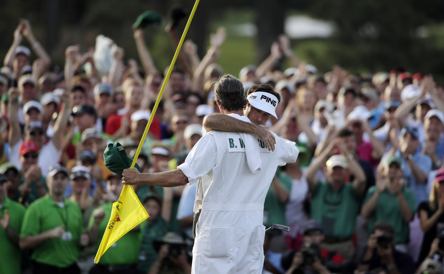Bubba Watson gets a hug from caddie Ted Scott after winning the Masters golf tournament Sunday, April 13, 2014, in Augusta, Ga.