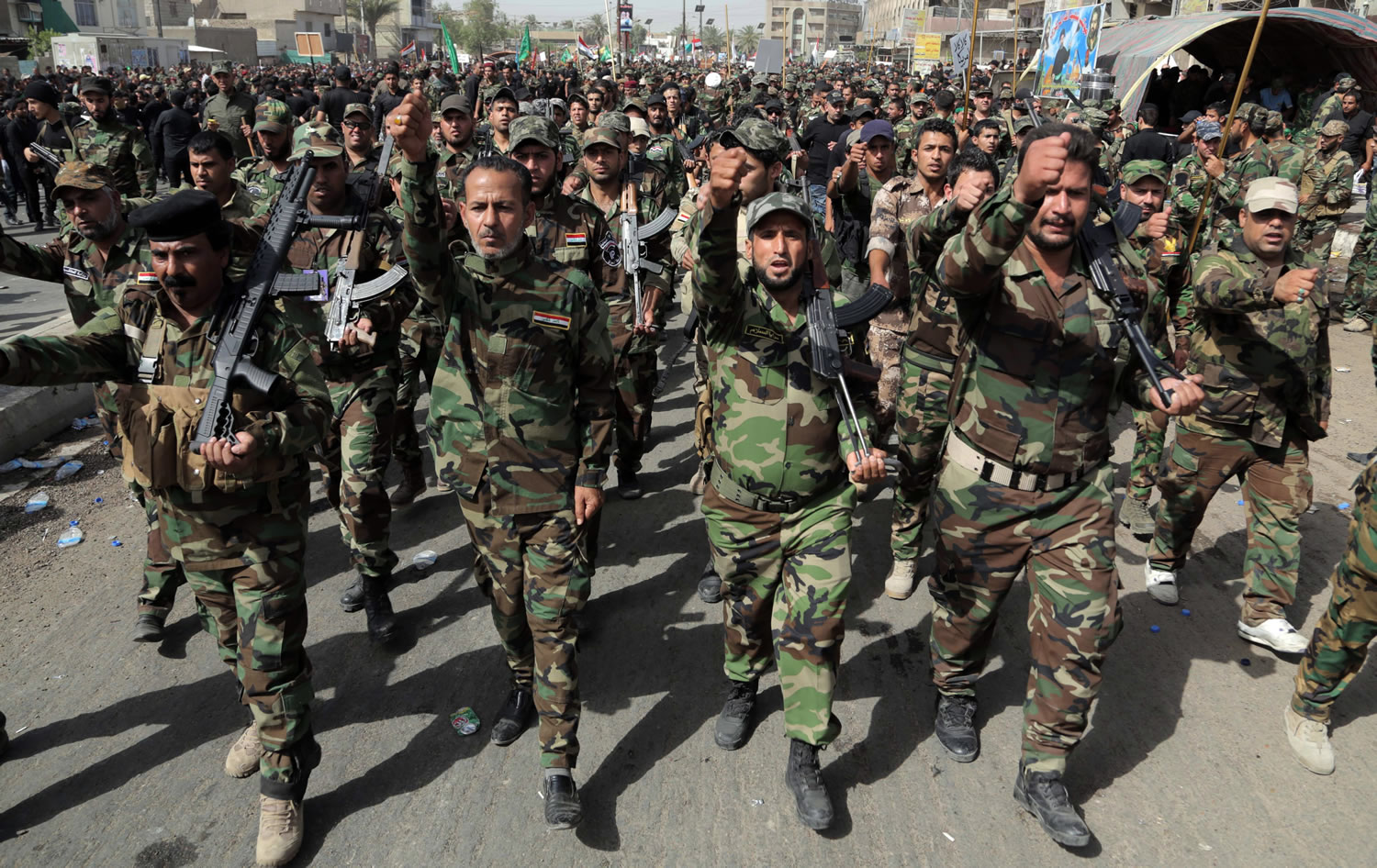 Volunteers of the newly formed u201cPeace Brigadesu201d participate in a parade in the Shiite stronghold of Sadr City, Baghdad, Iraq, on Saturday.