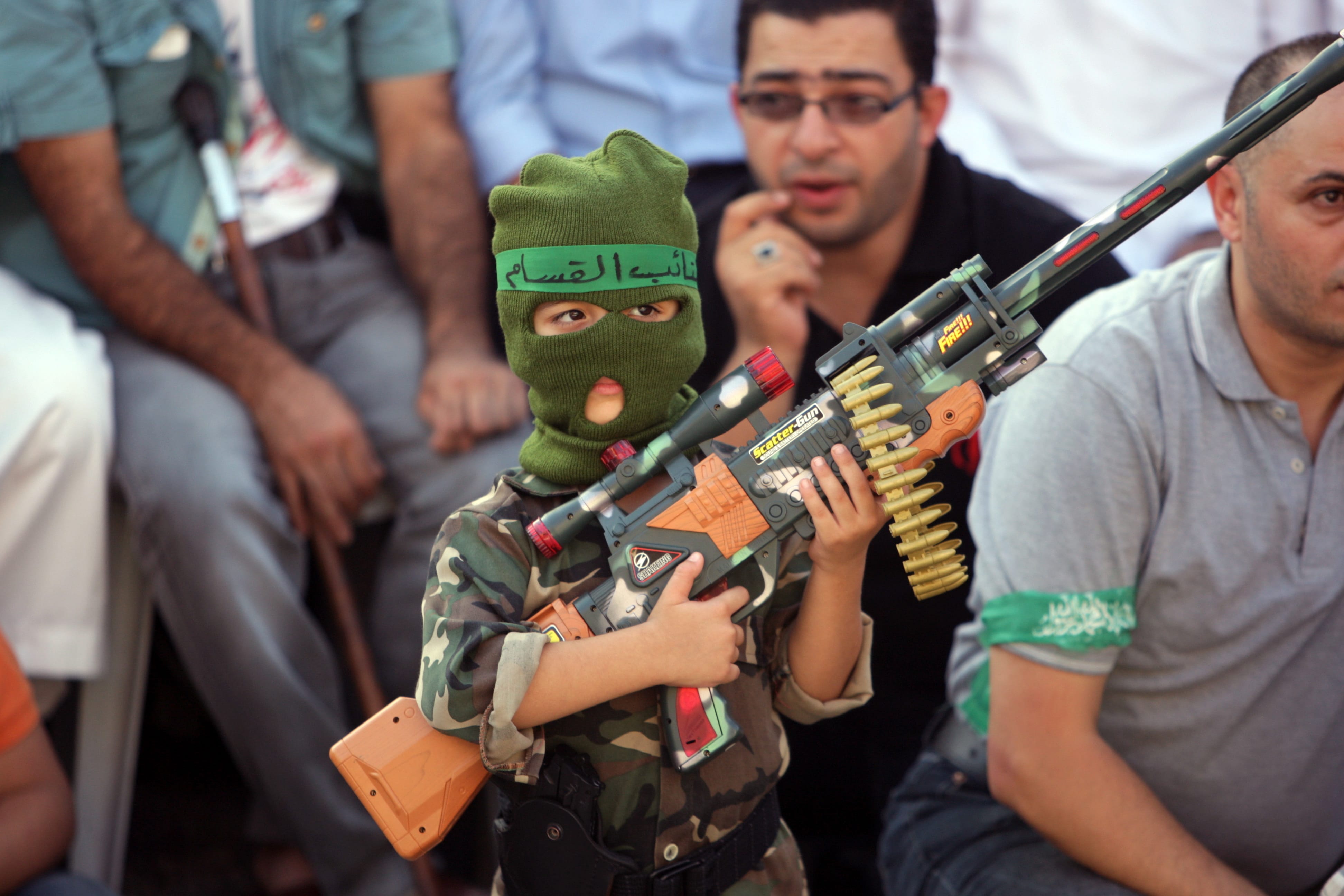 A Palestinian boy holds a toy gun during a celebration organized by Hamas in the West Bank city of Nablus, on Friday.