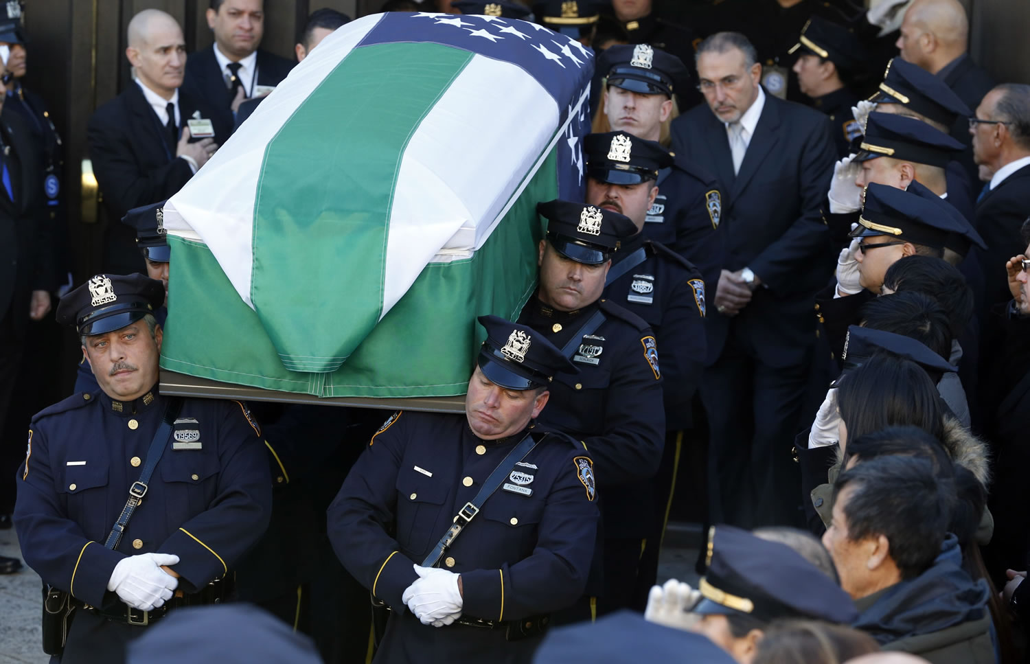 Pallbearers carry the casket of New York City police officer Rafael Ramos following funeral services at Christ Tabernacle Church, in the Glendale section of Queens, Saturday, Dec. 27, 2014, in New York. Ramos and his partner, officer Wenjian Liu, were killed Dec. 20 as they sat in their patrol car on a Brooklyn street. The shooter, Ismaaiyl Brinsley, later killed himself.