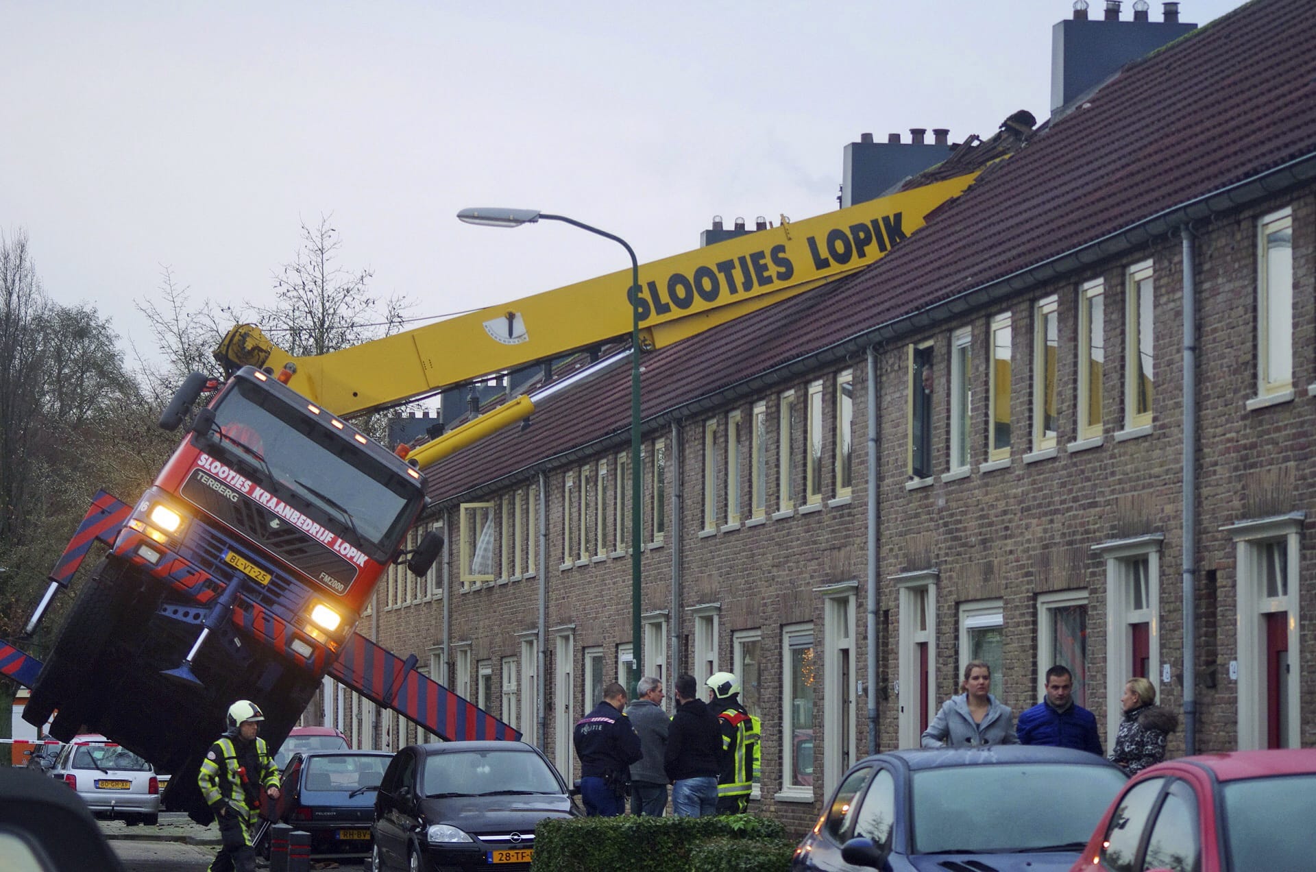 A crane which crashed into the roof of a house is seen following an unusual marriage proposal by a man who wished to be lifted in front of the bedroom window of his girlfriend to ask for her hand in marriage, in the central Dutch town of IJsselstein, Saturday Dec. 13, 2014. No people were injured in the accident, the groom-to-be jumped to safety without injuries and his girlfriend accepted to marry him, according to local Dutch media.