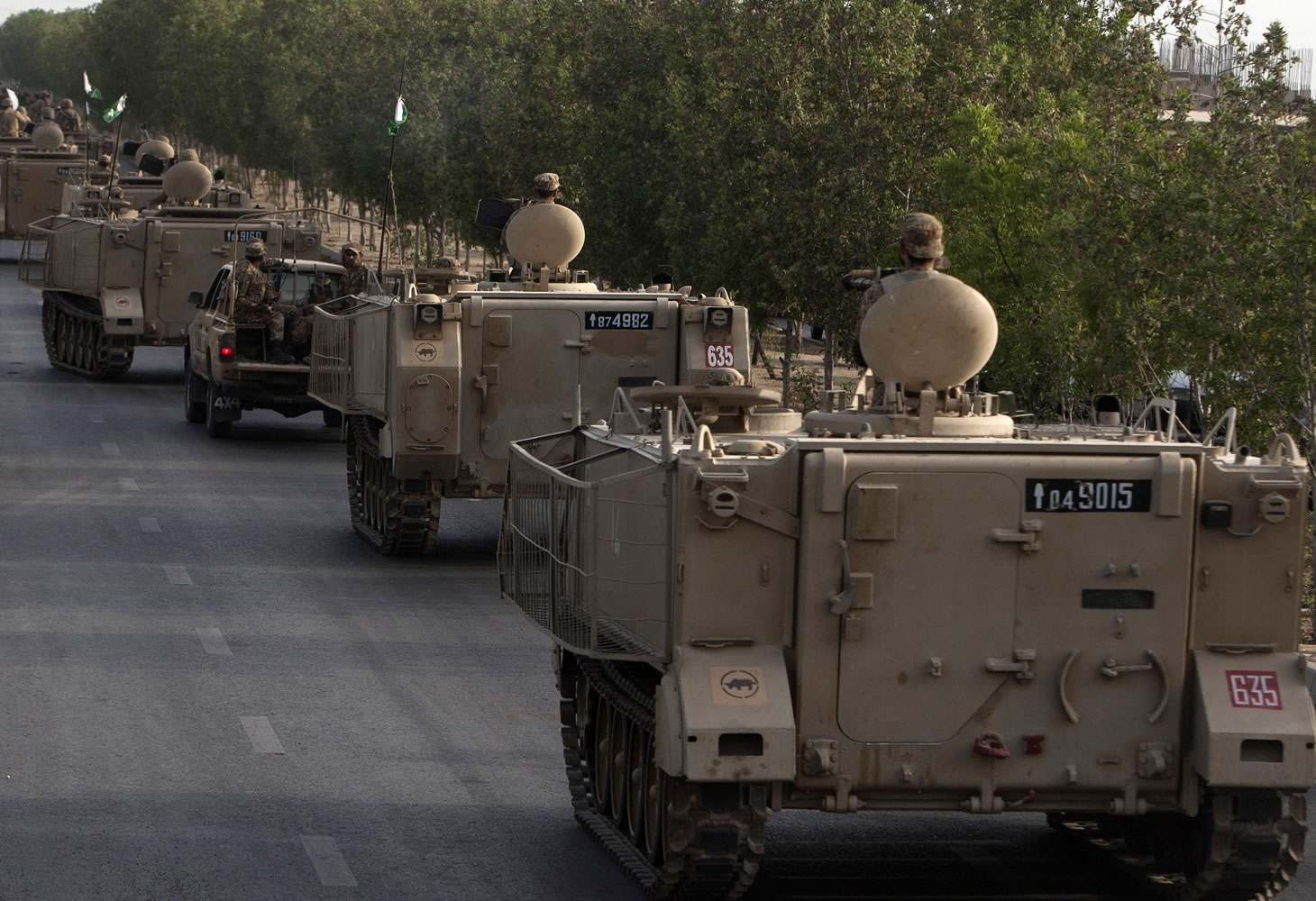 Pakistani army troops ride military vehicles Monday in Karachi, Pakistan, after launching an offensive against the Taliban in North Waziristan.