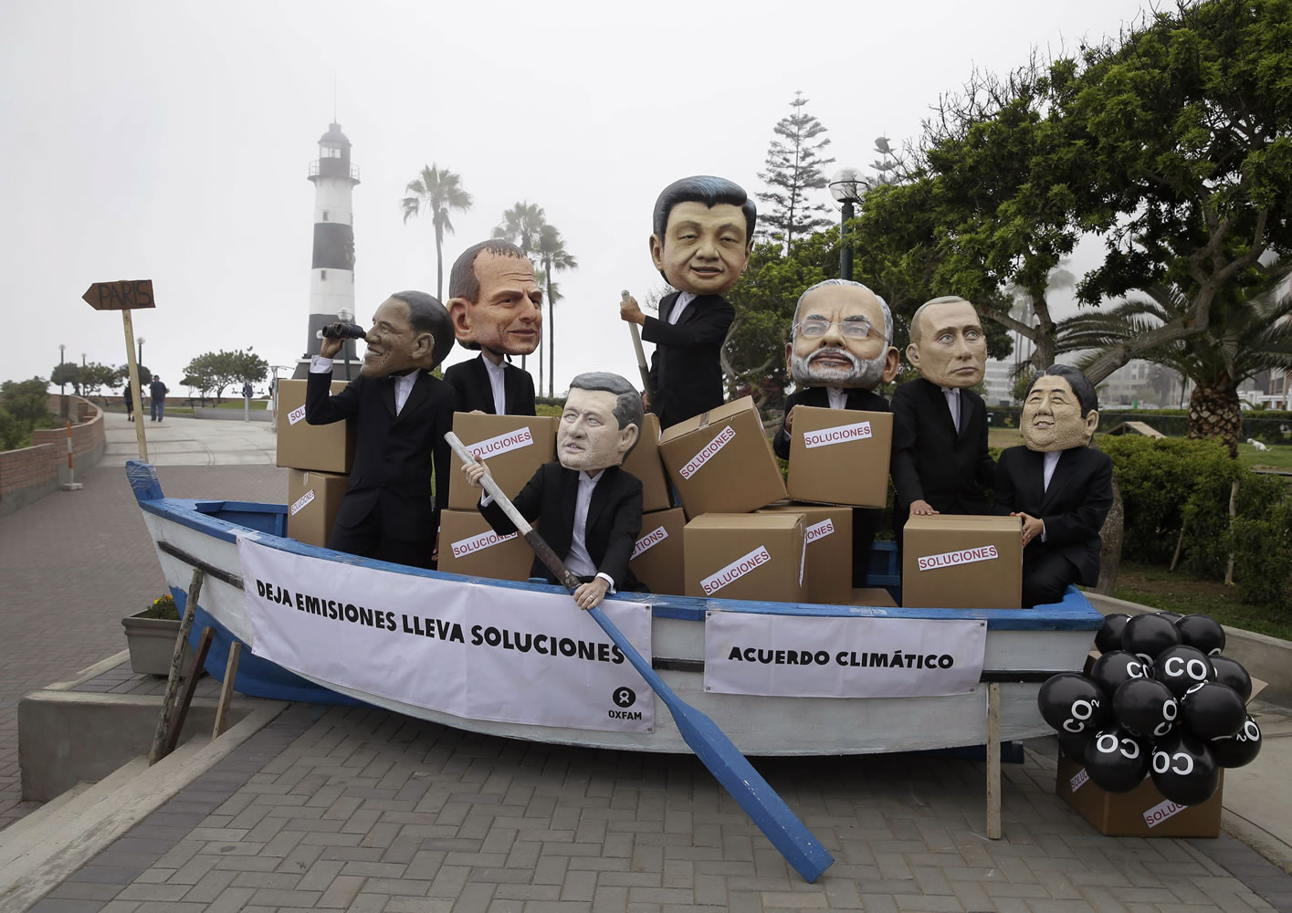 Activists perform as heads of state, from left, President Barack Obama, Australia's Prime Minister Tony Abbott, Canada's Prime Minister Stephen Harper, China's President Xi Jinping, India's Narendra Modi, Russia's President Vladimir Putin and Japan's Prime Minister Shinzo Abe during Friday the Climate Change Conference COP20 in Lima Peru.