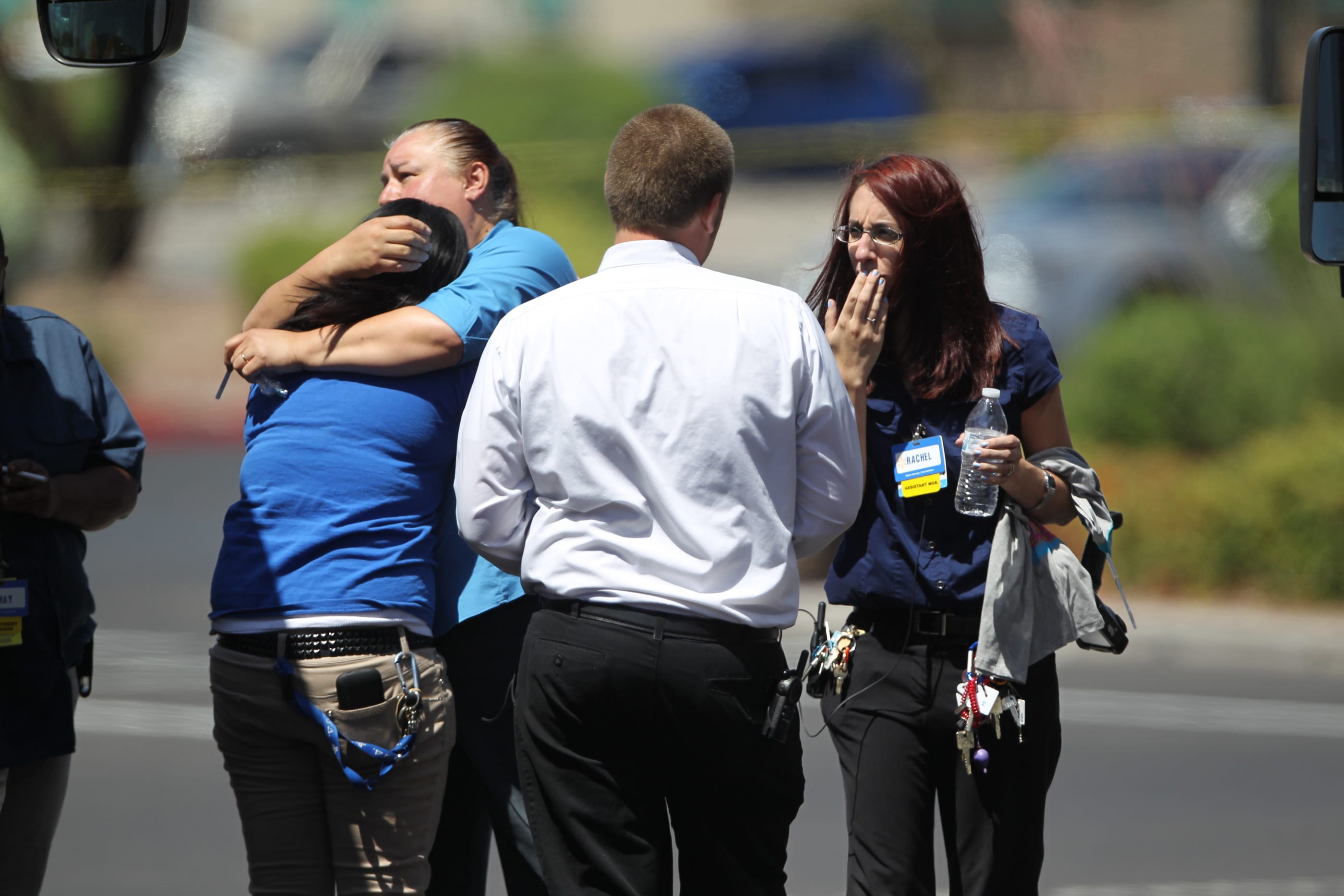 Wal-Mart employees hug outside a store after a shooting at the store and a nearby CiCiis Pizza in Las Vegas on Sunday.