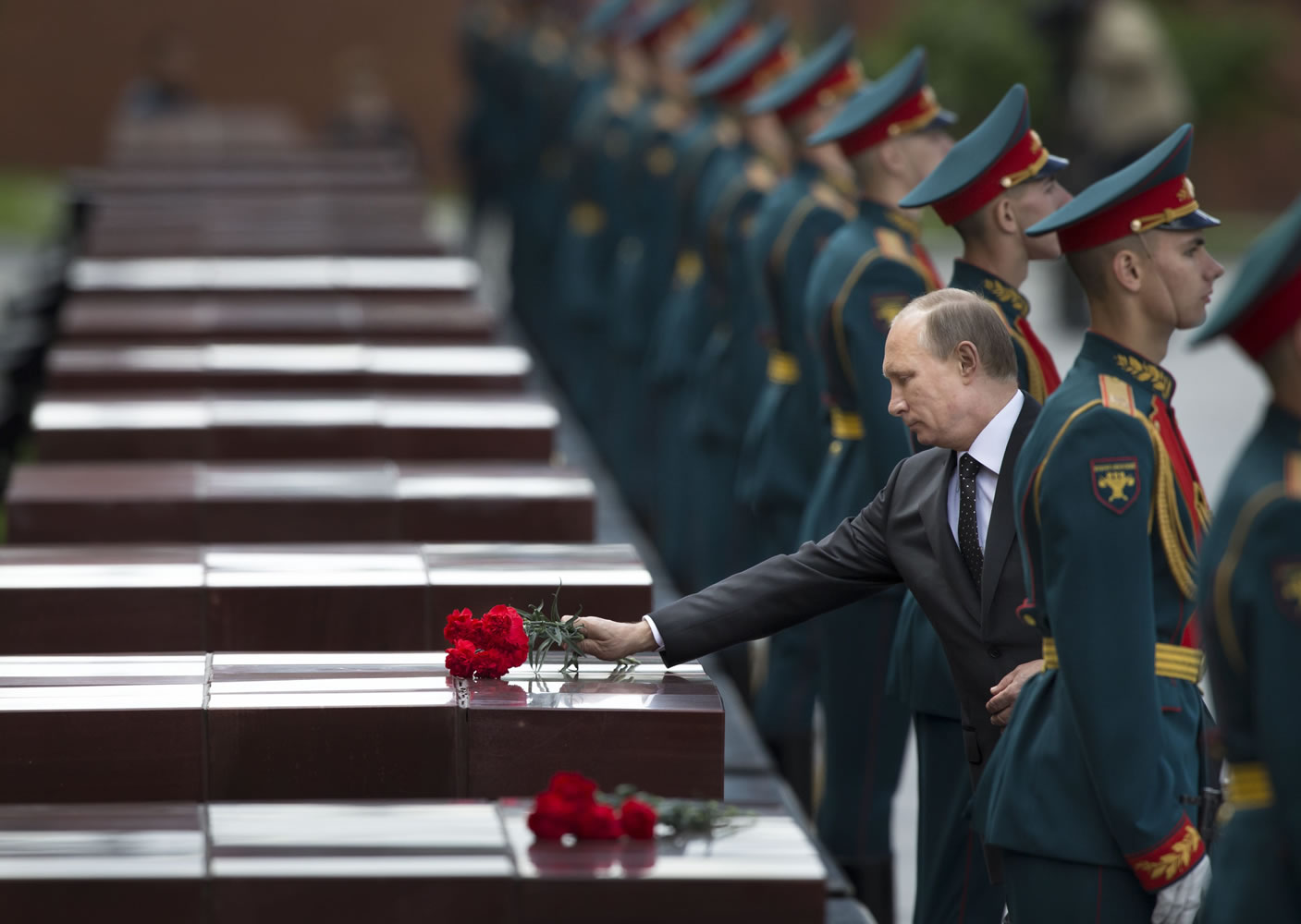 Russian President Vladimir Putin, second from right, takes part in a wreath-laying ceremony Sunday at the Tomb of the Unknown Soldier outside Moscowu2019s Kremlin Wall to mark the 73rd anniversary of the Nazi invasion of the Soviet Union.