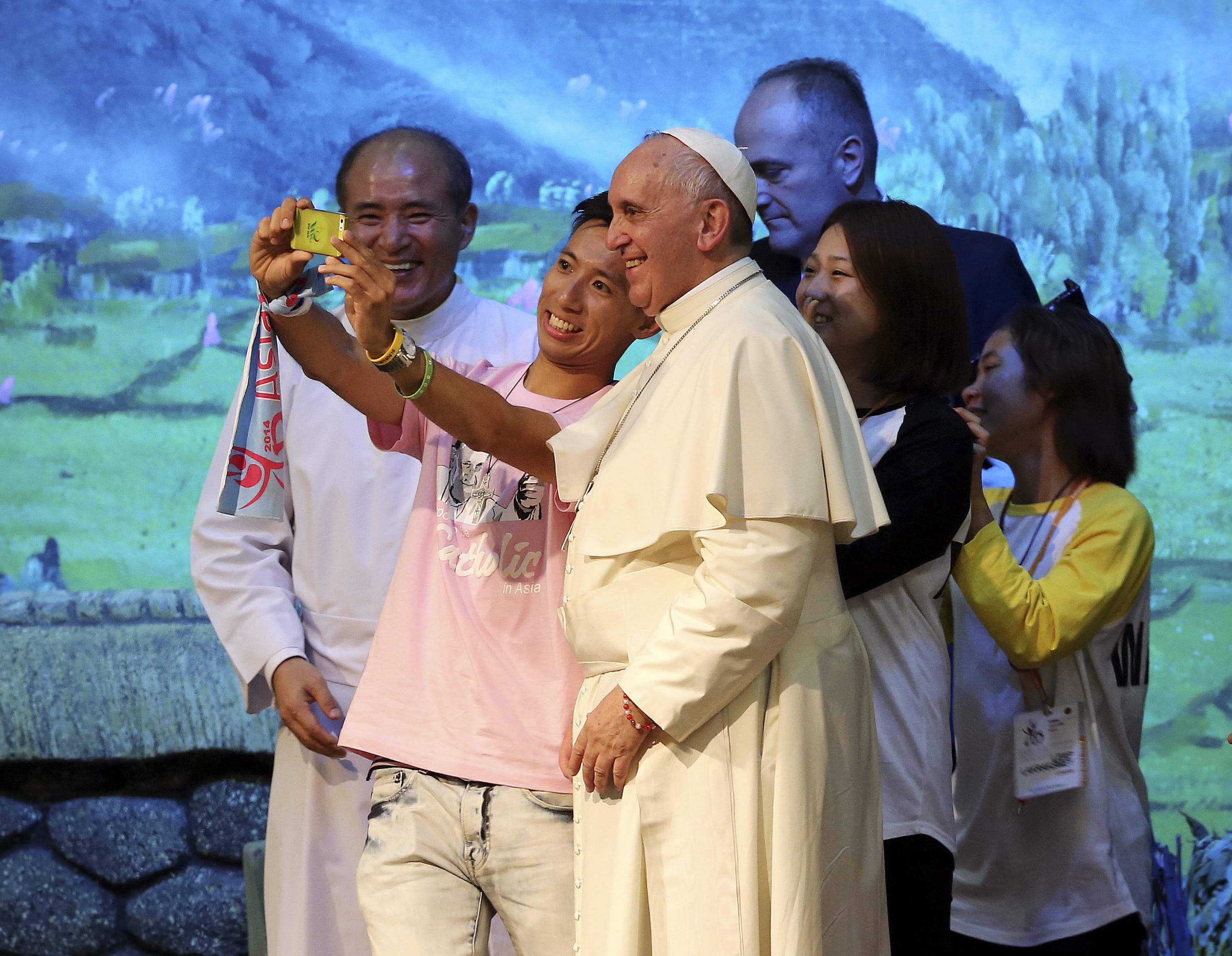 Pope Francis poses for a selfie Friday, Aug. 15, with young participants during a meeting with Asian youth at the Solmoe Sanctuary in Dangjin, South Korea.