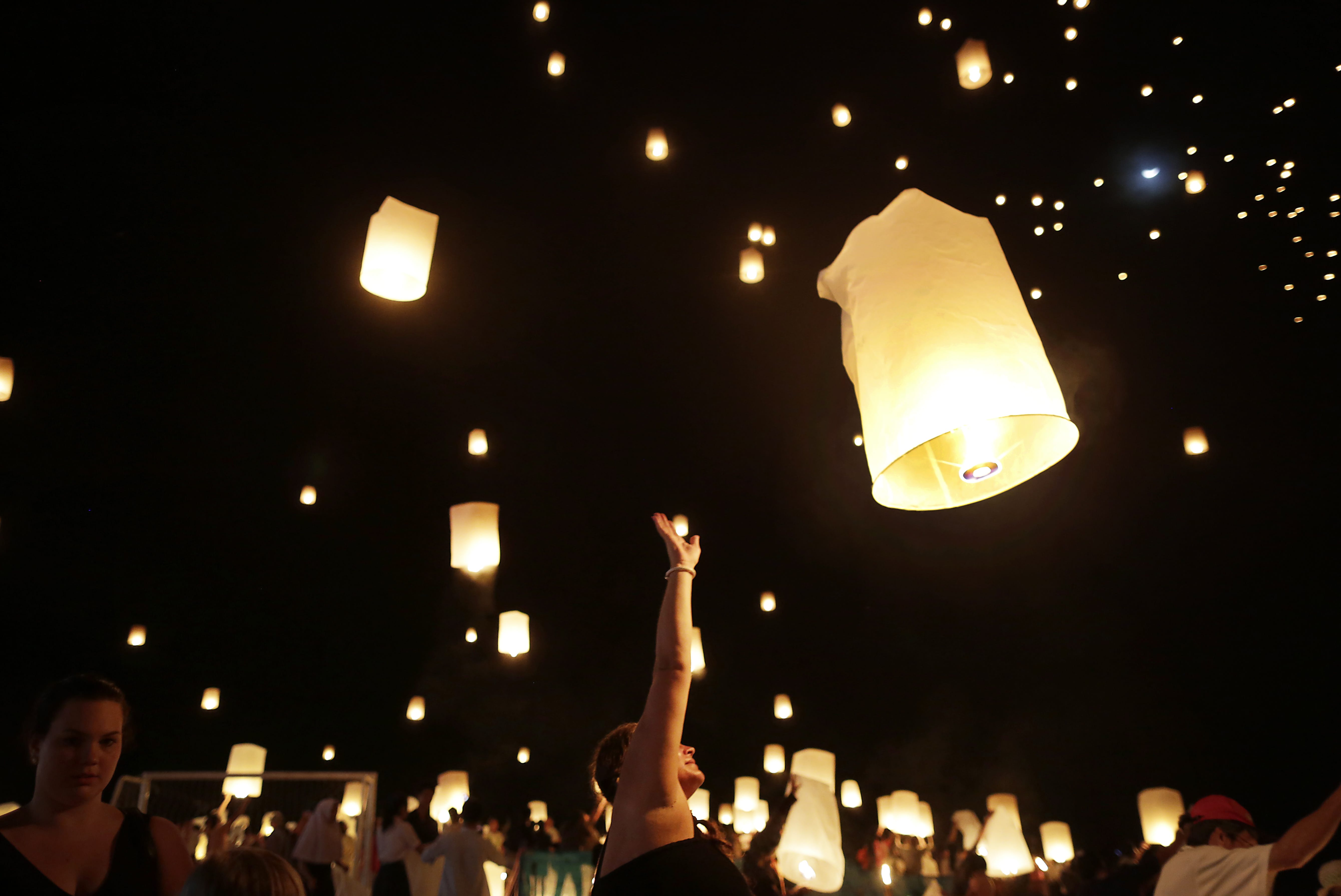 Jenny Brand of Sweden, center, who had friends killed in the 2004 Asian tsunami, releases a lantern symbolizing the releasing of spirits amid hundreds of others Friday during a service to mark the 10th anniversary of the disaster in Ban Nam Khem, Thailand.