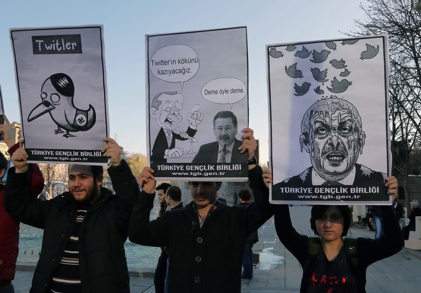 Members of the Turkish Youth Union hold cartoons depicting Turkey's Prime Minister Recep Tayyip Erdogan during a protest against a ban on Twitter in Ankara, Turkey, on Friday.