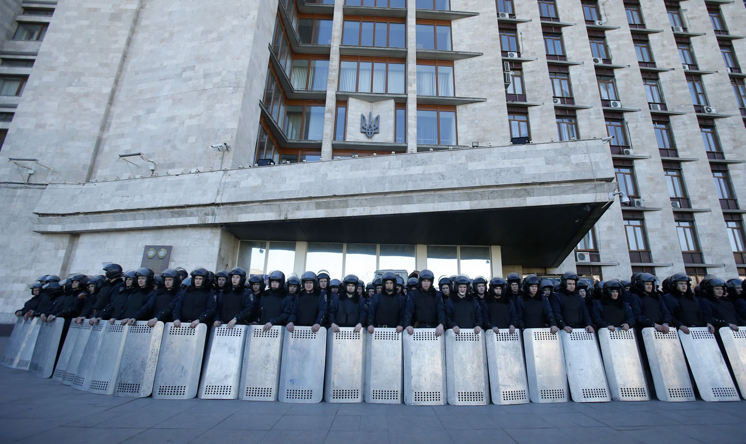 Ukrainian riot police block the entrance of the regional administrative building, during a pro Russian rally in Donetsk, eastern Ukraine, Sunday, March 23, 2014.