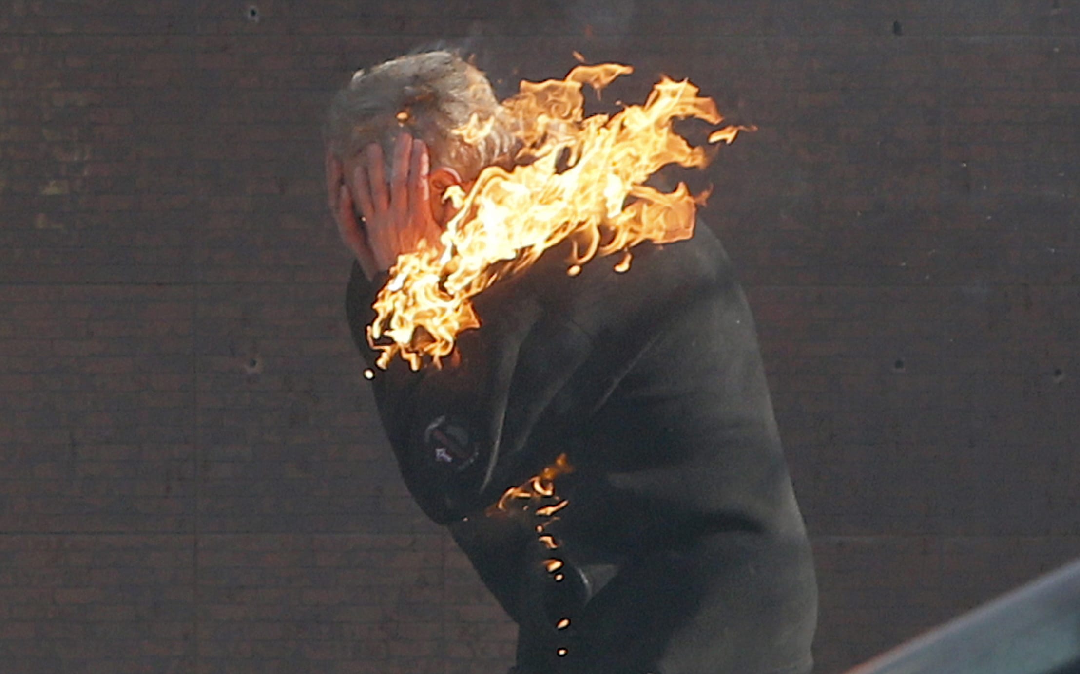 An anti-government protester burns during clashes with riot police Tuesday outside Ukraine's parliament in Kiev.