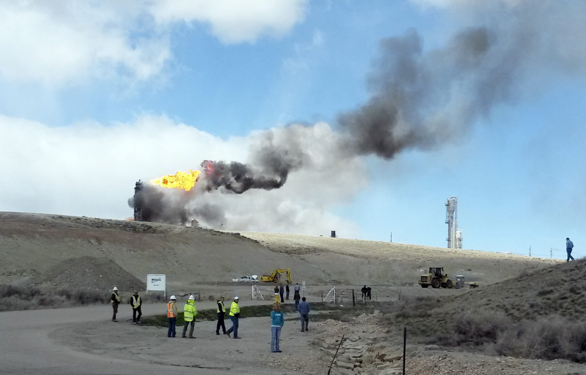 Smoke rises at the site of an explosion and fire at a natural gas processing facility and major national pipeline hub on Wednesday in Opal, Wyo.