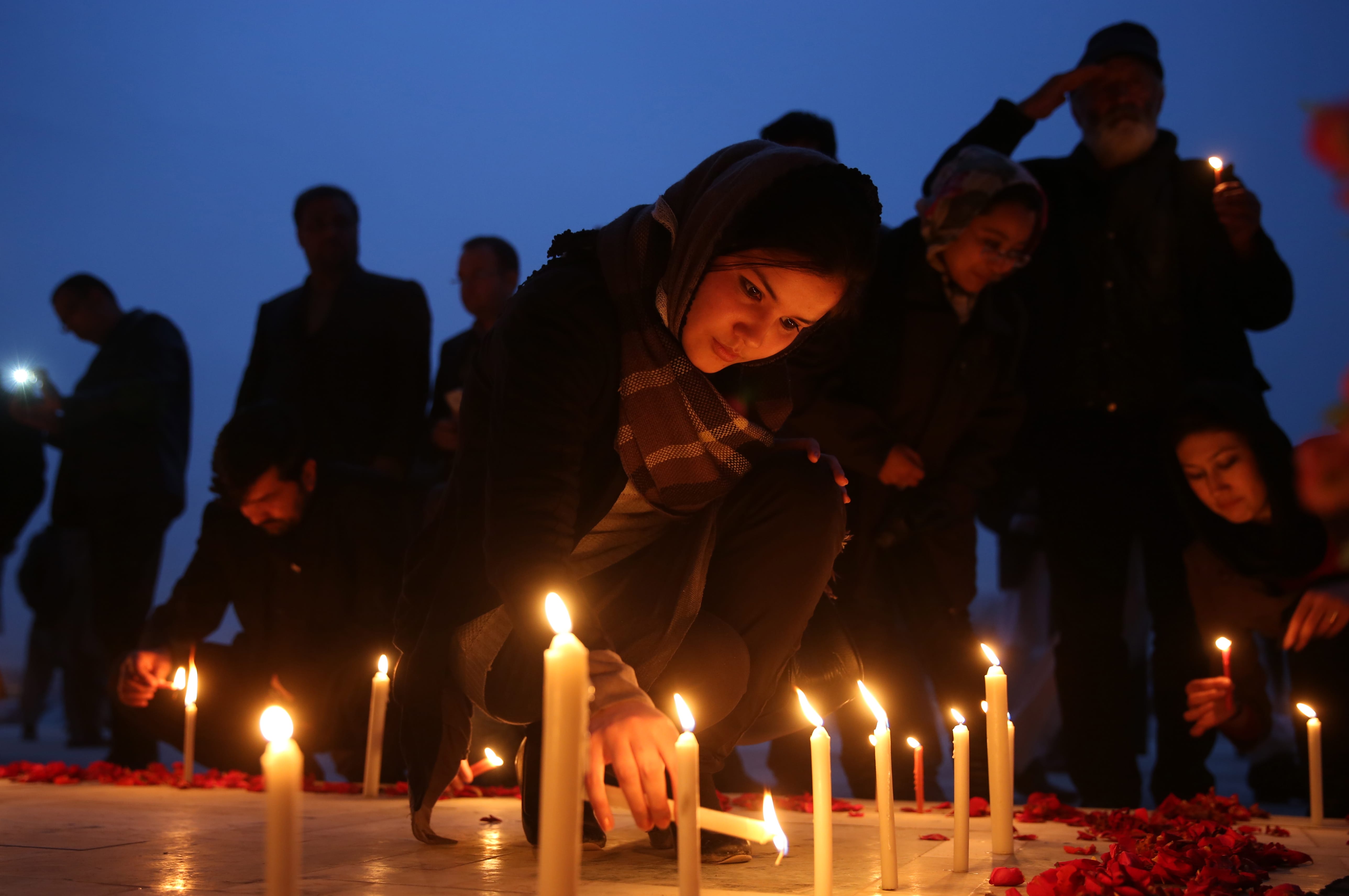 Afghan members of civil society organizations light candles during a memorial ceremony for 21 Afghan National Army  soldiers in Kabul, Afghanistan, on Tuesday.