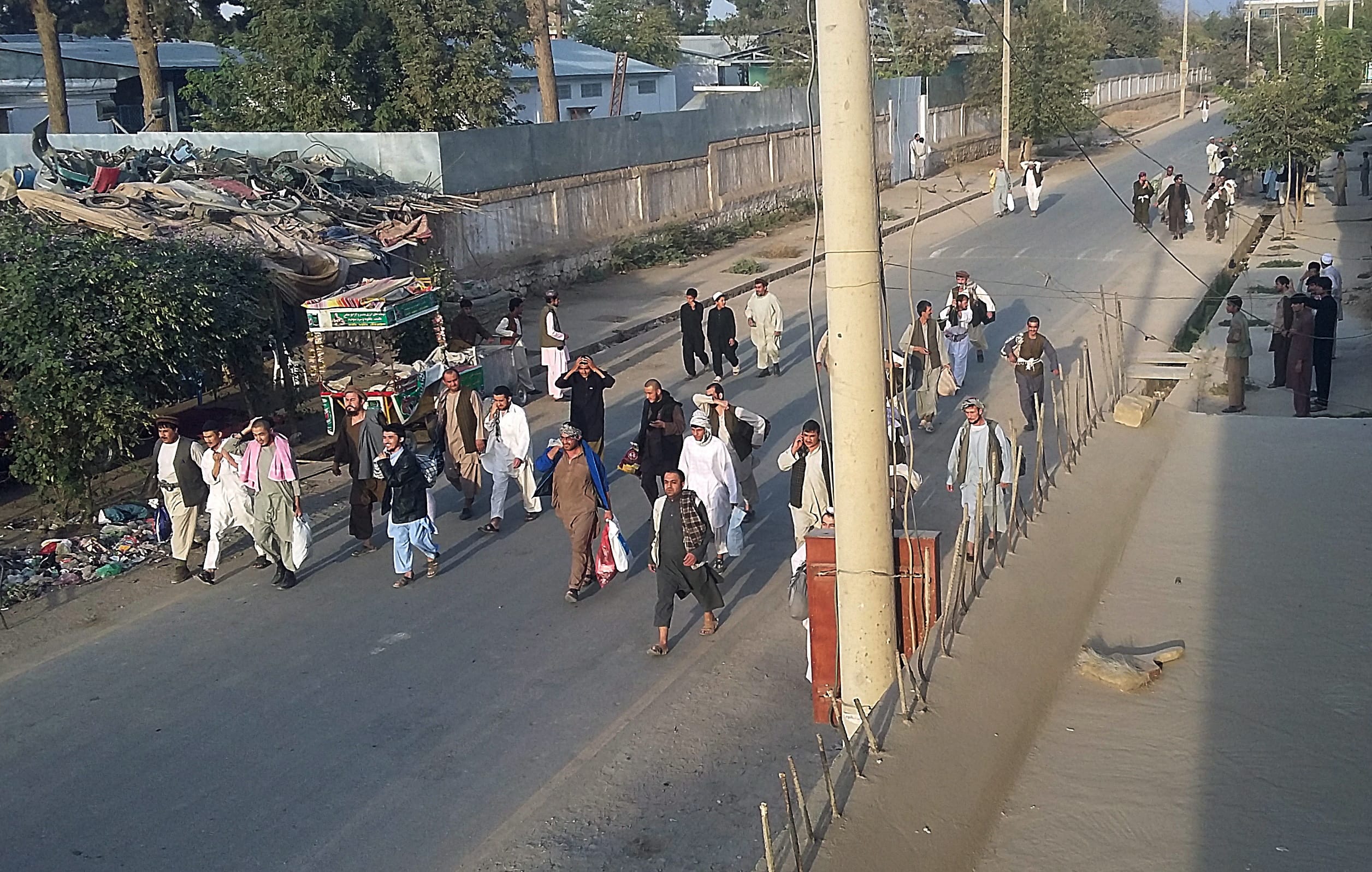 Taliban prisoners walk on a street Monday after their comrades released them from the main jail in Kunduz, north of Kabul, Afghanistan. The Taliban captured the northern Afghan city of Kunduz in a massive assault Monday involving hundreds of fighters.
