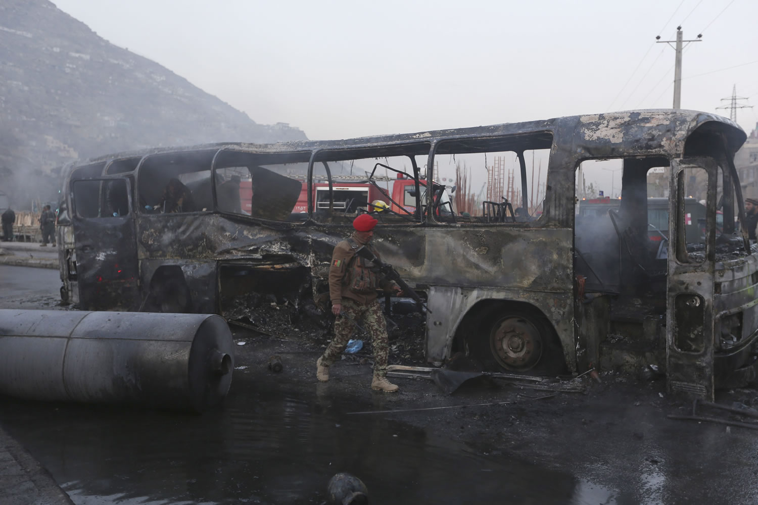 An Afghan soldier inspects a damaged bus Dec. 13 at the site of a suicide attack by the Taliban in Kabul, Afghanistan. With U.S.-led forces shifting to a supporting role at the end of this month, Afghanistan will have to chart its own course after the country's bloodiest year since the 2001 invasion, a year which saw record casualties among Afghan civilians and security forces alike.