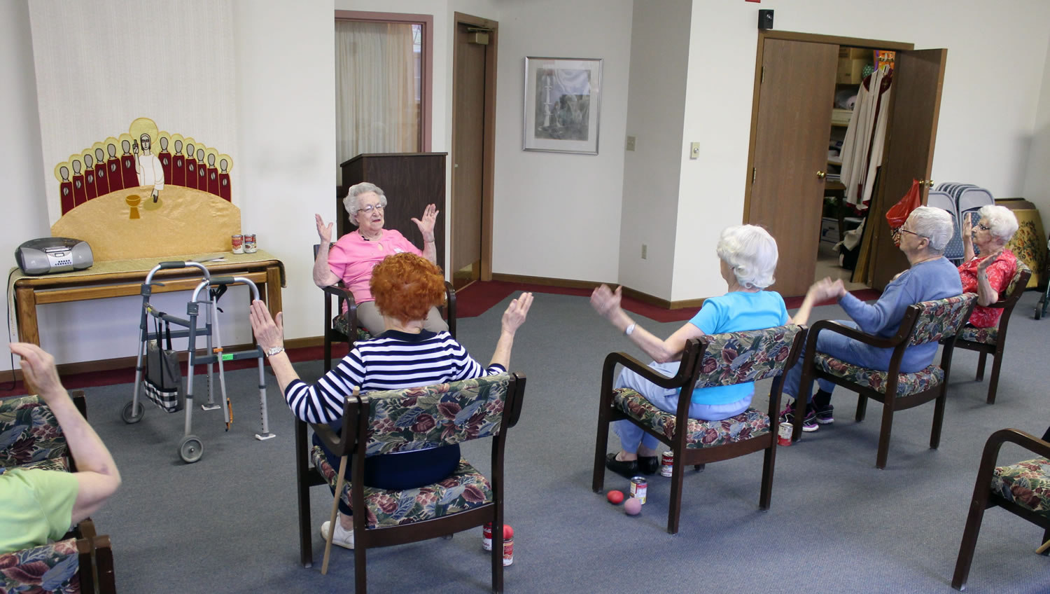 Hildegard Gigl, top, leads an exercise class at Hawthorne Terrace independent retirement center in Wauwatosa, Wis. Gigl, who turns 99 in June, is the oldest one in the class.