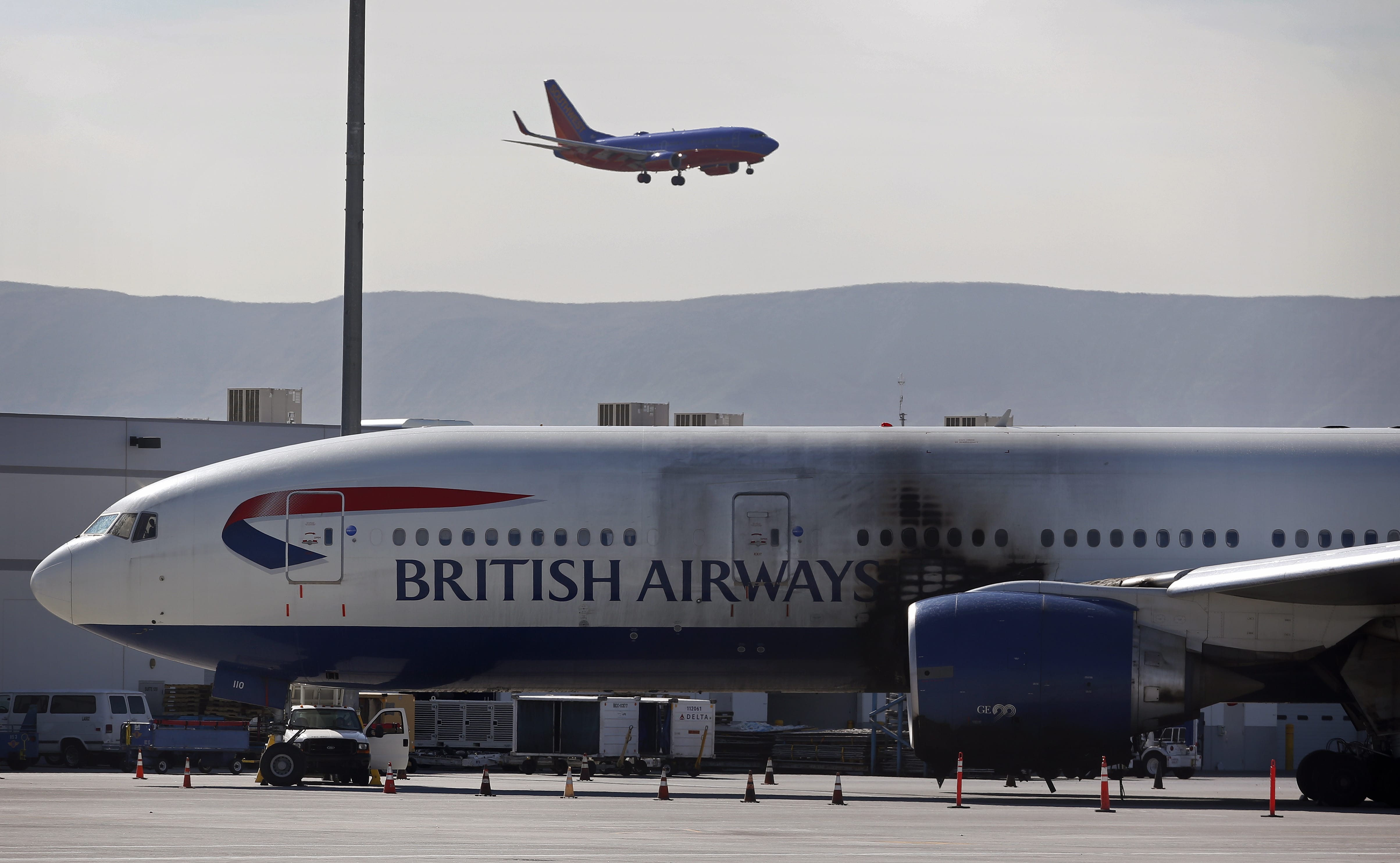 A damaged British Airways Boeing 777-200 sits at McCarran International Airport Wednesday, Sept. 9, 2015, in Las Vegas. An engine caught fire before takeoff Tuesday forcing the evacuation of the crew and passengers.