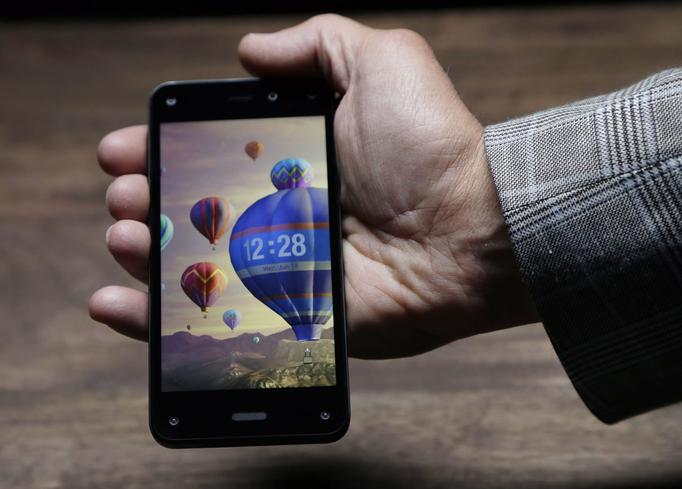 The new Amazon Fire Phone displays a dynamic perspective effect lock screen image.