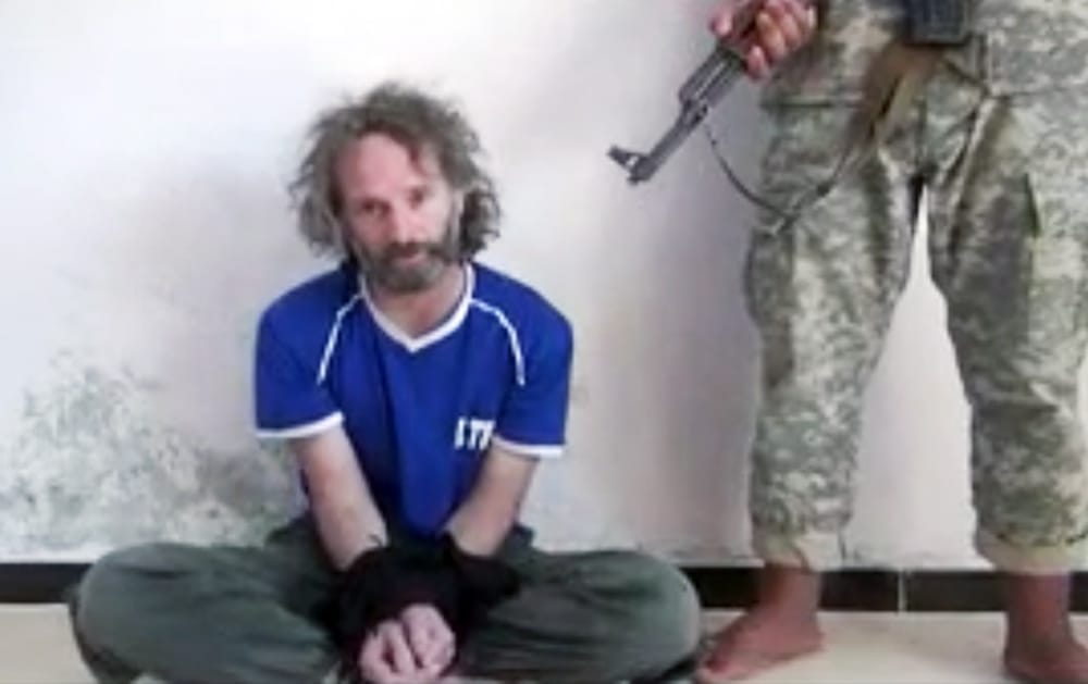 In this image made from undated video obtained by The Associated Press, which has been authenticated based on its contents and other AP reporting, a man believed to be Peter Theo Curtis, a U.S. citizen held hostage by an al-Qaida linked group in Syria, delivers a statement. The U.S.