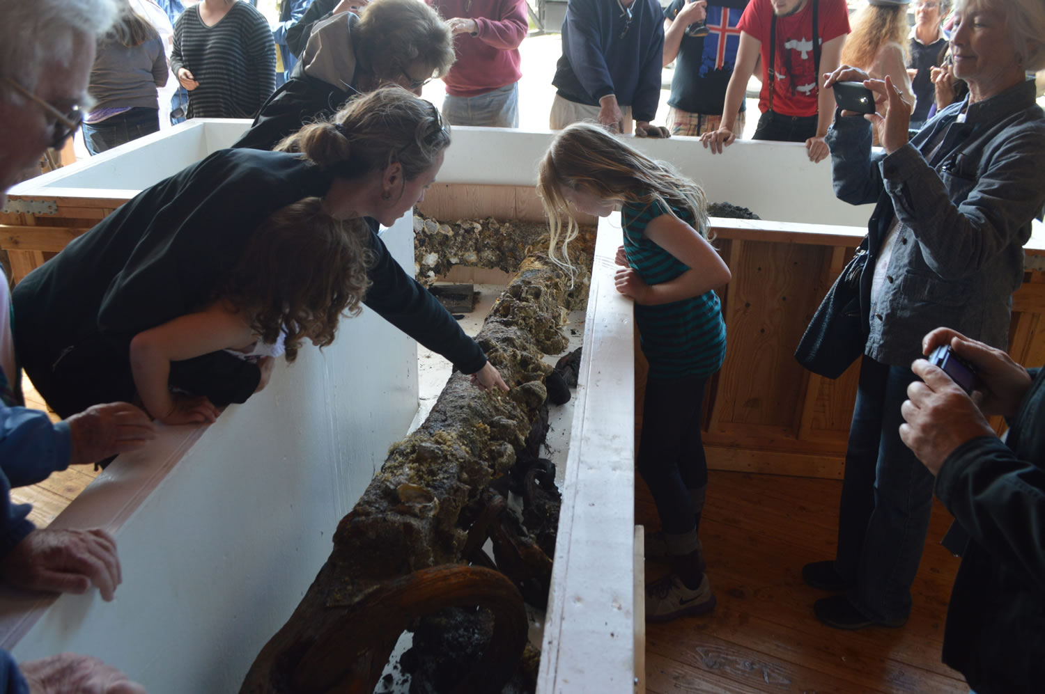 Crowds at the Northwest Maritime Center in Port Townsend examine on Tuesday what might be an anchor from one of British explorer George Vancouver's sailing fleet that explored the Northwest Washington and British Columbia waters more than 200 years ago. The anchor was hoisted from the bottom of Admiralty Inlet between Port Townsend and Whidbey Island the day before after being submerged for more than 200 years, its salvagers say.