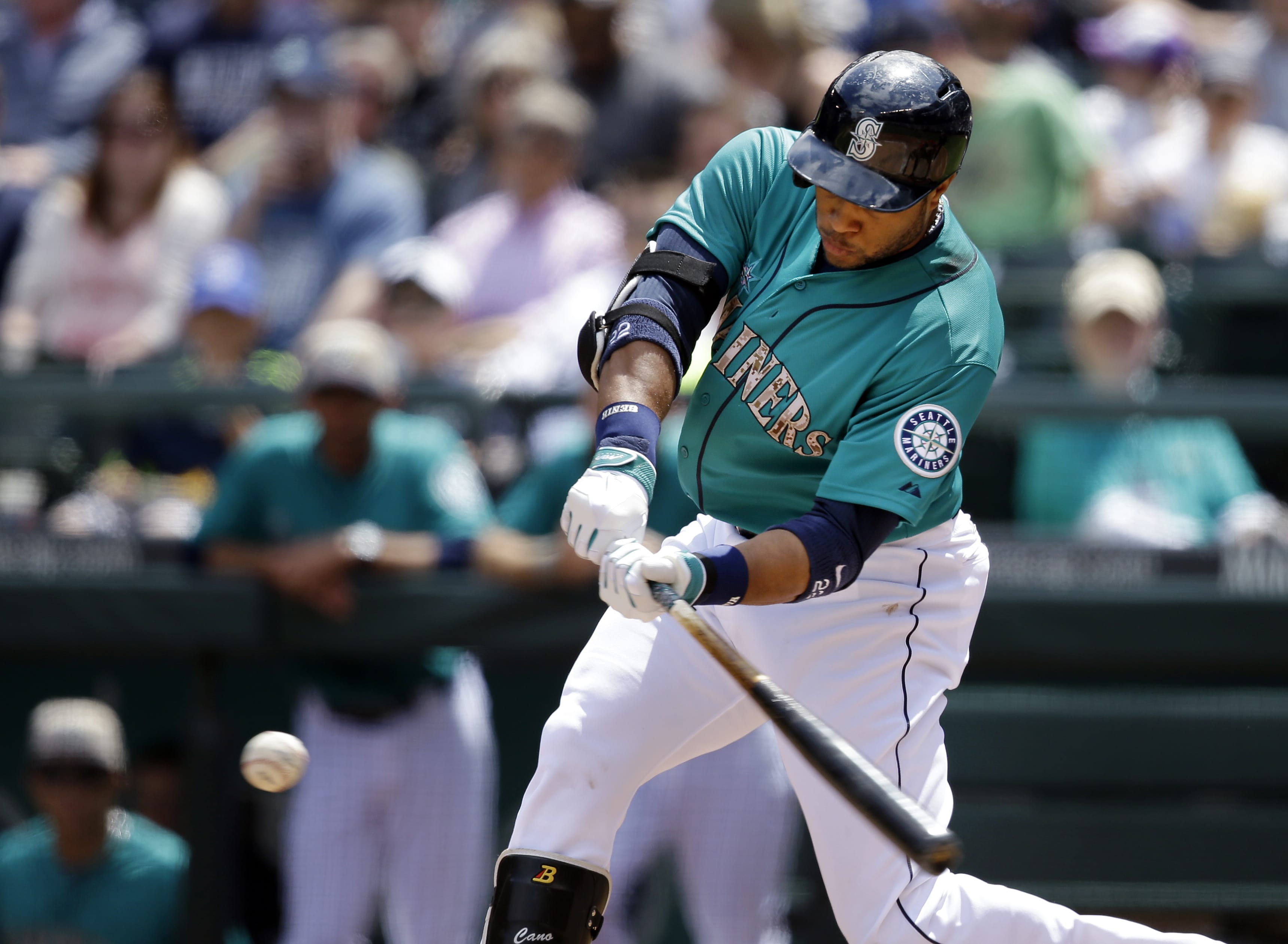 Seattle Mariners' Robinson Cano singles in a run against the Los Angeles Angels in the first inning of a baseball game Monday, May 26, 2014, in Seattle.