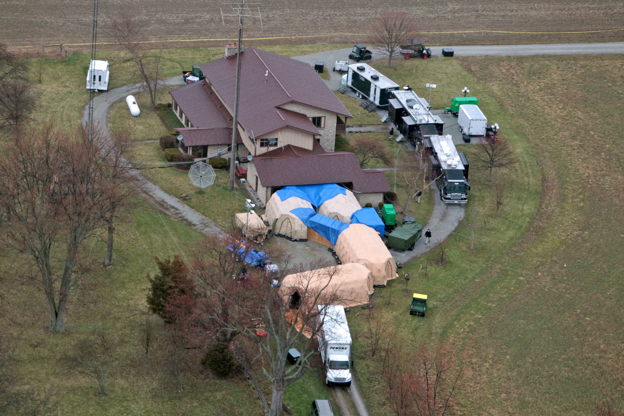 In this aerial photo, FBI agents work around the home of 91-year-old Donald Miller in Waldron, Ind., on Wednesday.  Authorities seized thousands of Native American, Russian, Chinese and other artifacts that have &quot;immeasurable&quot; cultural value from Miller's private collection, the FBI said Wednesday.