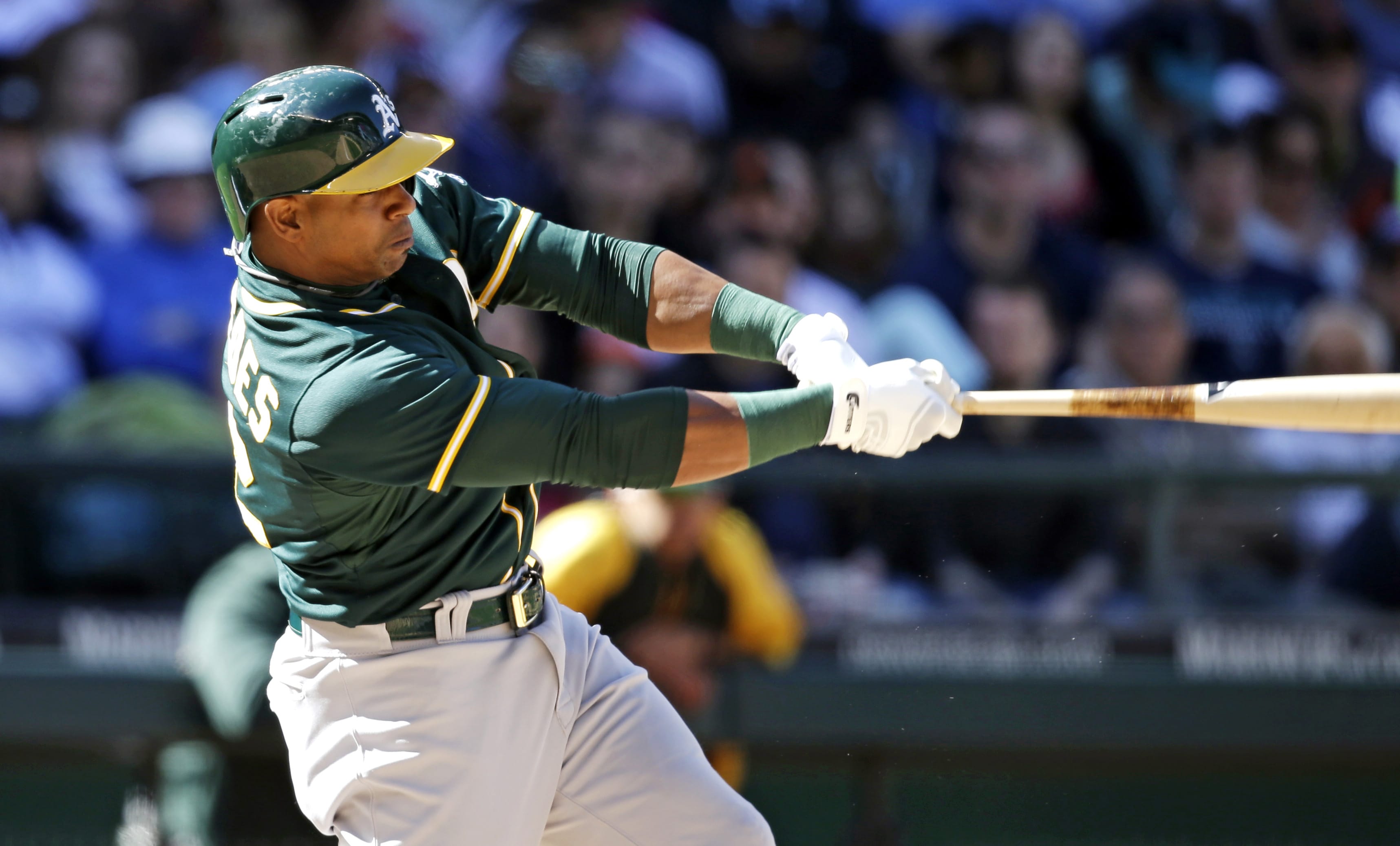 Oakland Athletics' Yoenis Cespedes hits a two-run home run against the Seattle Mariners in the eighth inning of a baseball game Sunday, April 13, 2014, in Seattle.