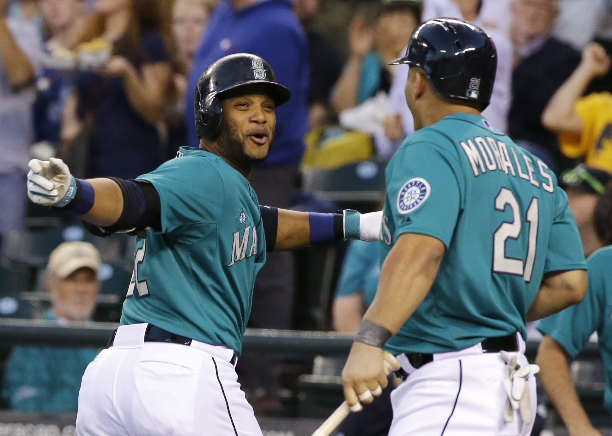 Seattle Mariners Robinson Cano, left, celebrates with Kendrys Morales, right, after Cano hit a solo home run in the first inning against the Oakland Athletics, Friday, Sept. 12, 2014, in Seattle. (AP Photo/Ted S.