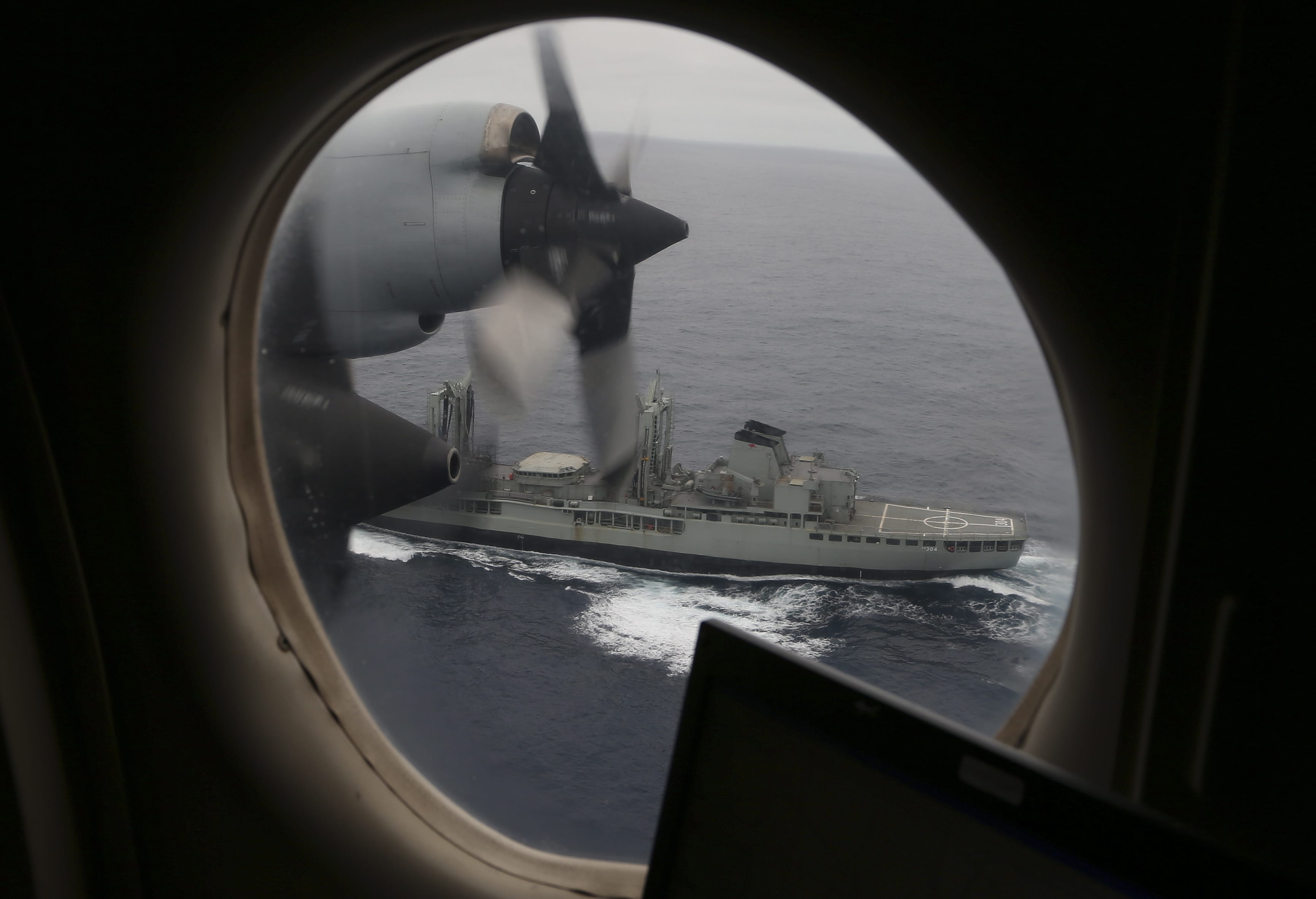 The Australian Navy's HMAS Success, seen from the window of a Royal Australian Air Force AP-3C Orion, searches for missing Malaysia Airlines flight MH370 in the southern Indian Ocean on Saturday.