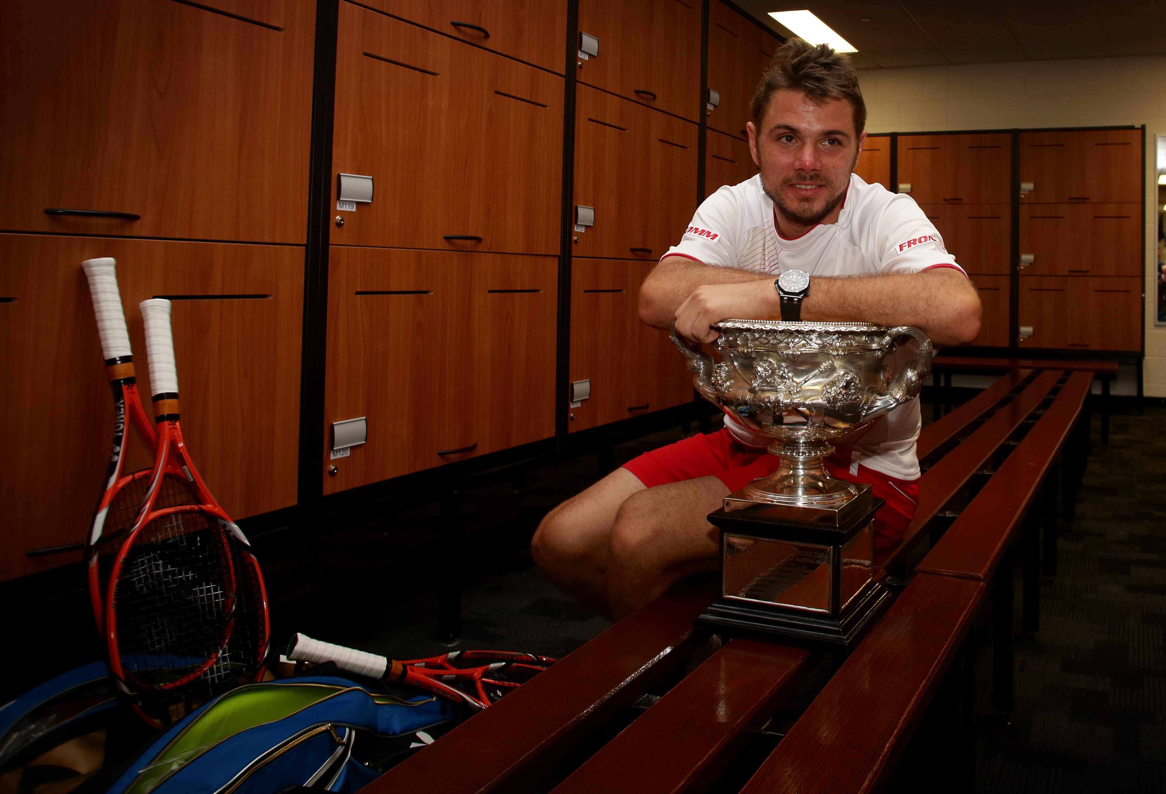In this photo released by Tennis Australia, Switzerland's Stanislas Wawrinka poses with the championship trophy at the players' locker room after defeating Spain's Rafael Nadal in the men's singles final at the Australian Open tennis championship in Melbourne, Australia, Sunday, Jan. 26, 2014.