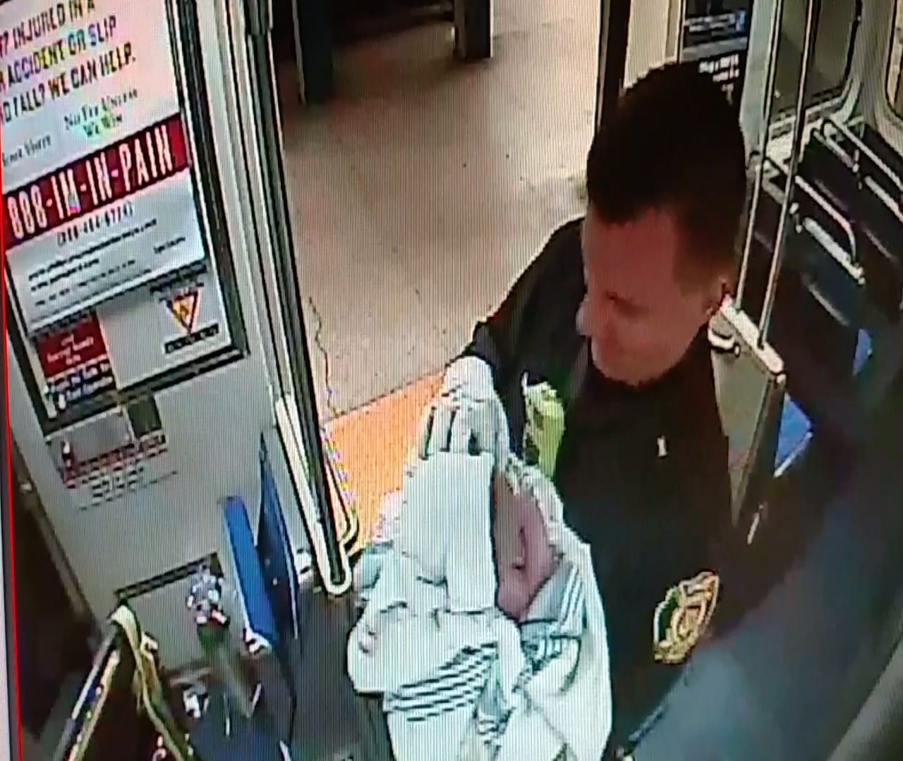 In this image from a Thursday surveillance video provided by the Southeastern Pennsylvania Transportation Authority, Philadelphia transit police Sgt. Daniel Caban holds a baby boy he helped deliver aboard a subway train at the 15th and Market streets station in Philadelphia. The mother and newborn were taken to Hahnemann University Hospital, where they were reported in good condition.
