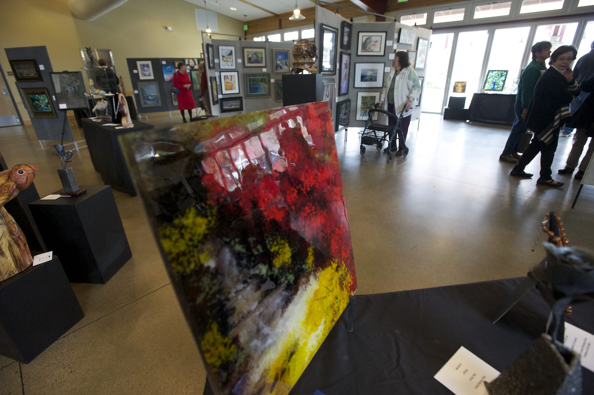 &quot;Red Waterfall,&quot; made from fused glass, by artist Ann Cavanaugh stands in the foreground as visitors enjoy the Battle Ground Art Alliance 12th annual Spring Show and Sale last year at the Battle Ground Community Center.
