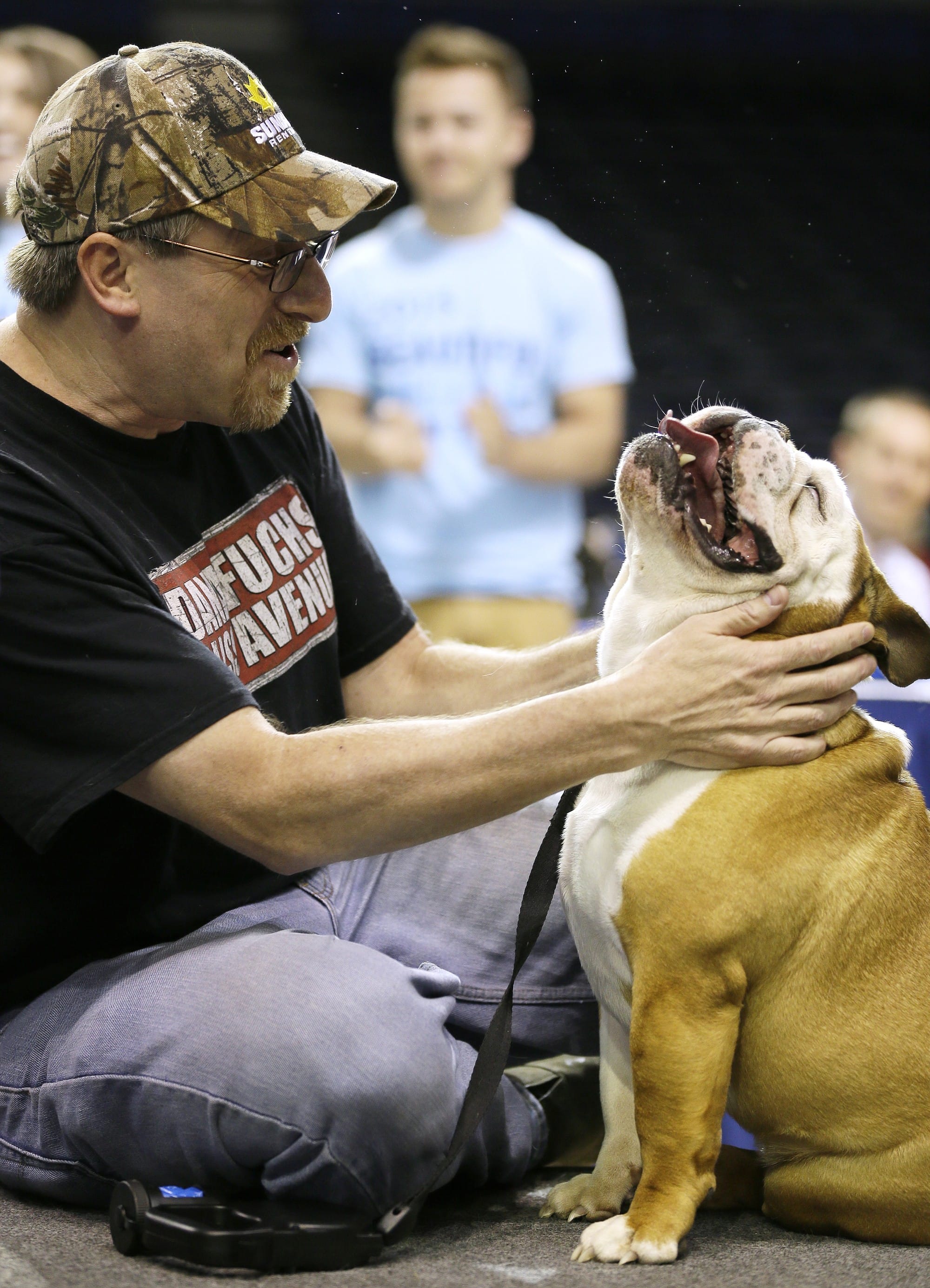 Duane Smith of Des Moines, Iowa, reacts with Tank on Sunday after the dog was named the winner of the 36th annual Drake Relays Beautiful Bulldog Contest in Des Moines.
