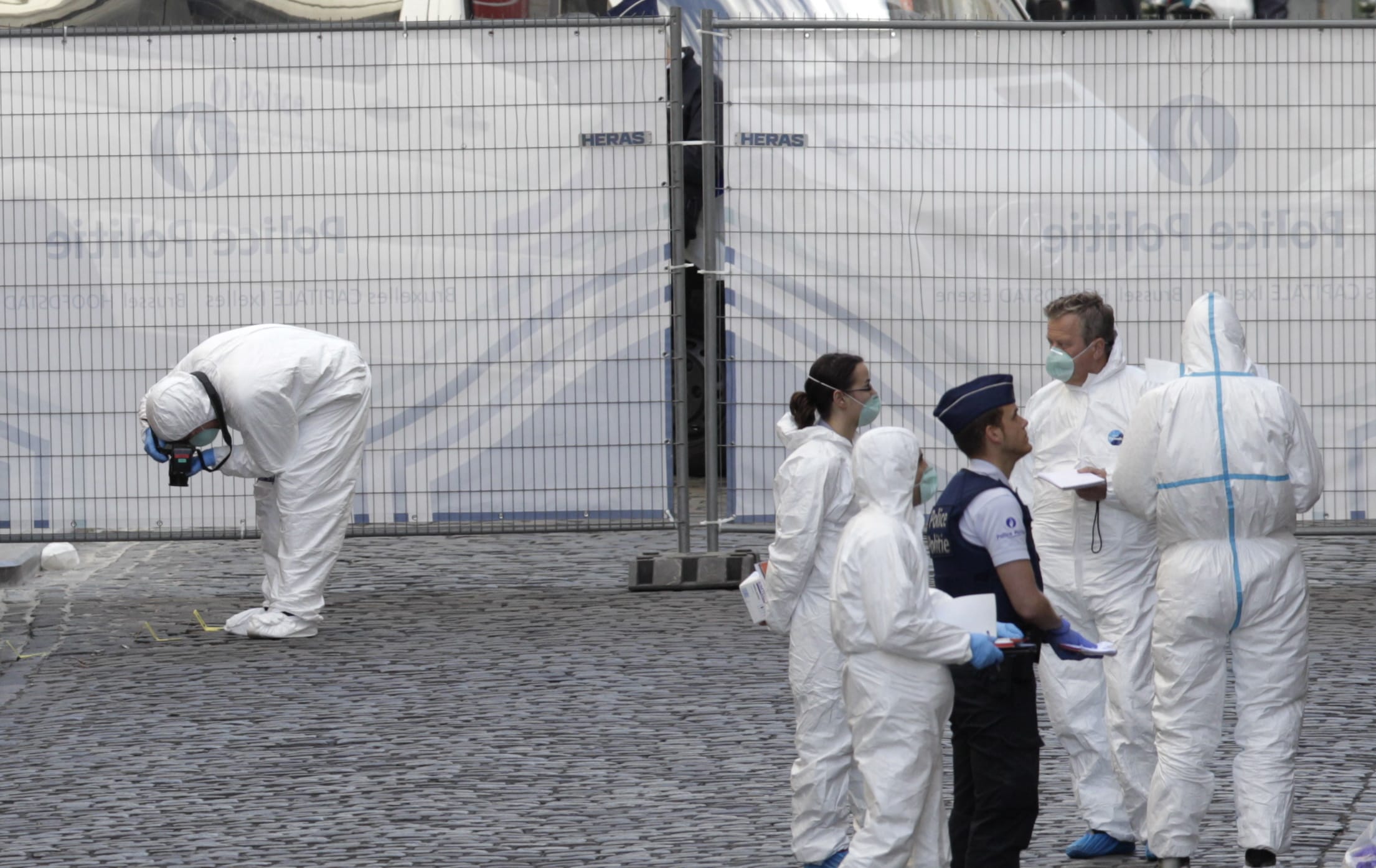 Forensic experts examine the site of a shooting at the Jewish Museum on Saturday in Brussels.