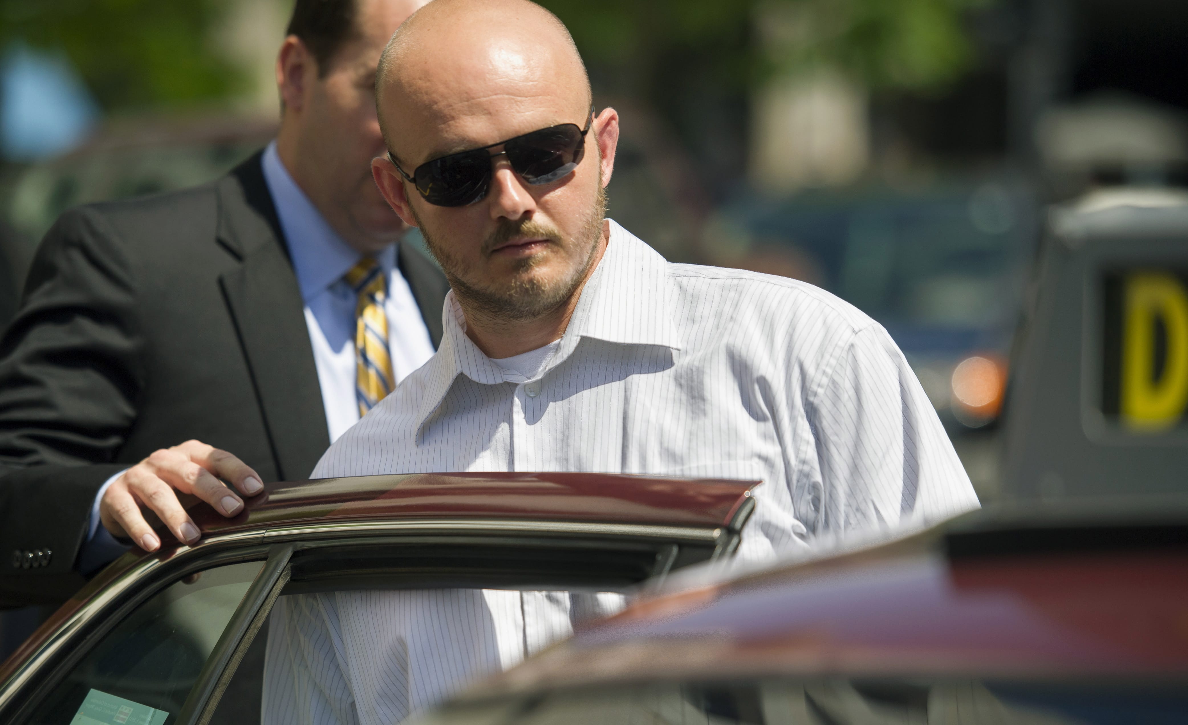 Former Blackwater Worldwide guard Nicholas Slatten enters a taxi cab as he leaves federal court in Washington, after the start of his trial.
