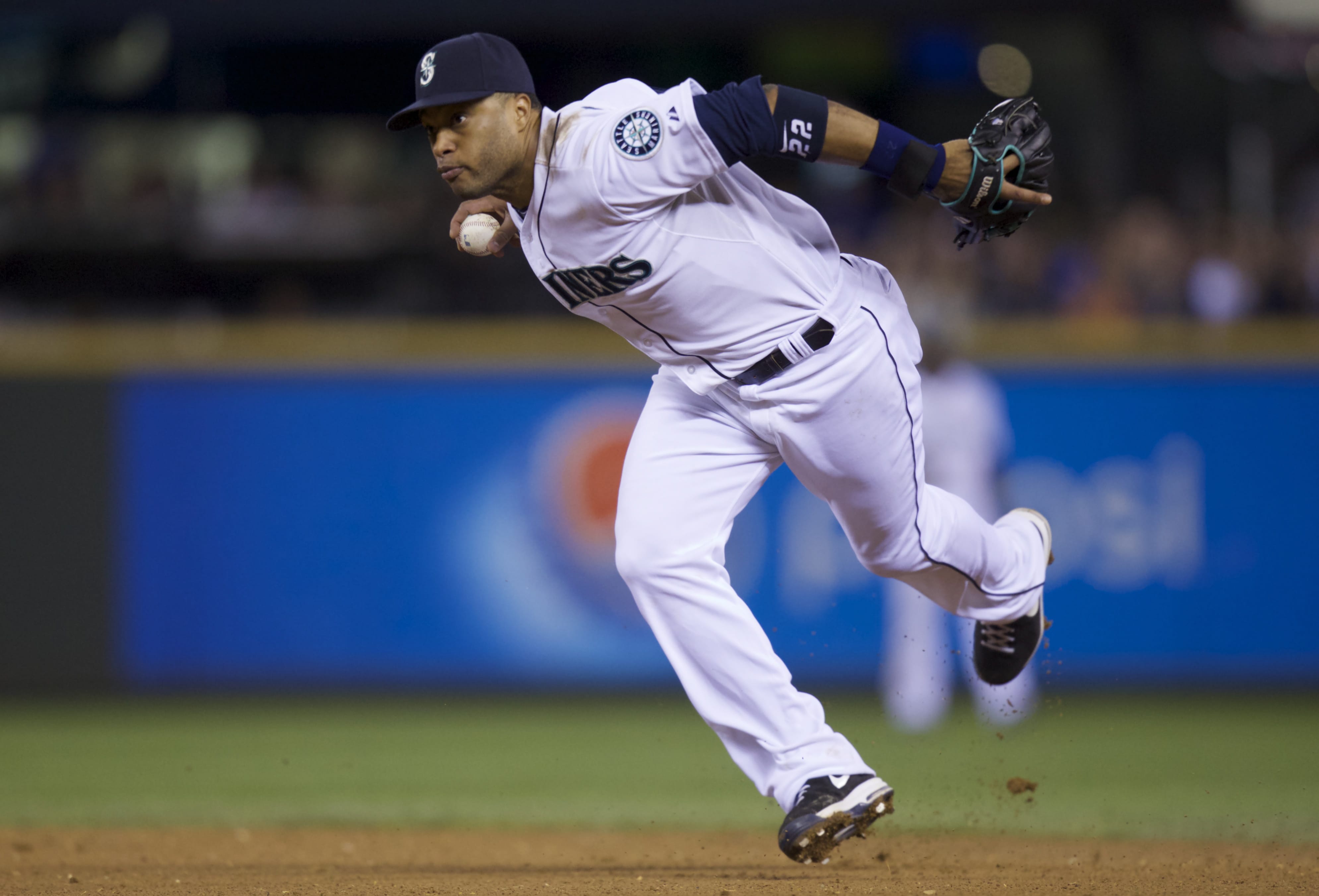 Seattle Mariners second baseman Robinson Cano throws a ball to first base after fielding deflection during the ninth inning a baseball game against the Toronto Blue Jays, Wednesday, Aug. 13, 2014, in Seattle. The Mariners won 2-0.