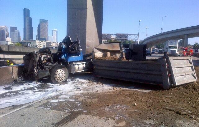 The Washington State Patrol says the driver responsible for a crash on Interstate 5 in downtown Seattle left the scene after causing a dump truck to overturn, spill its load and catch fire.
