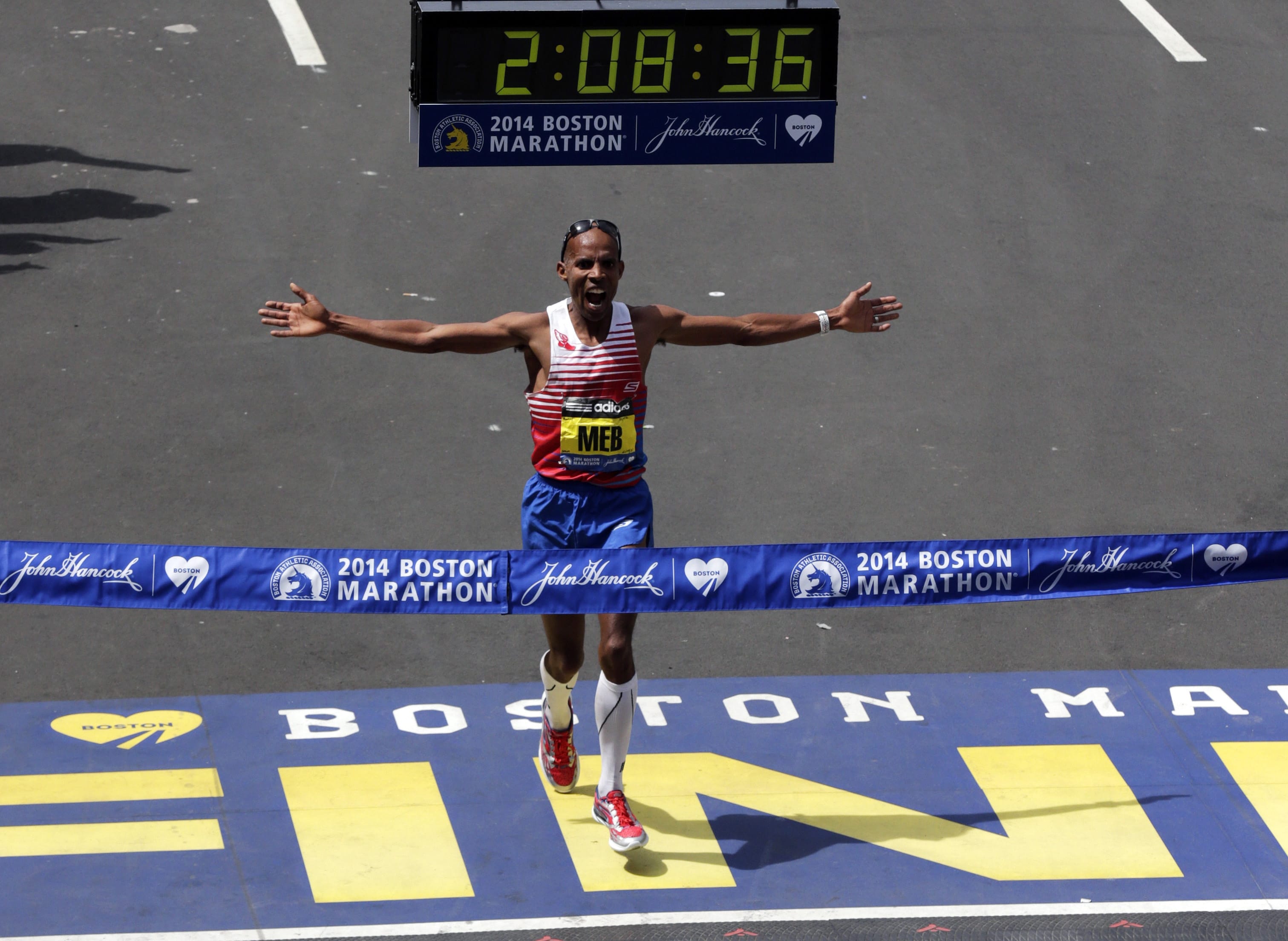Meb Keflezighi of San Diego celebrates as he crosses the finish line to win the 118th Boston Marathon on Monday in Boston.
