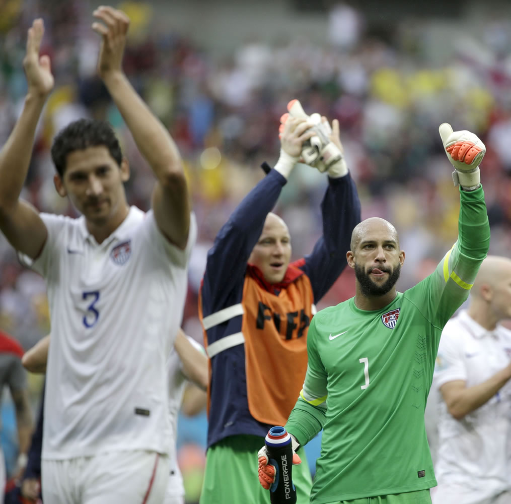 United States' goalkeeper Tim Howard (1) and his teammates celebrate after qualifying for the next World Cup round following their 1-0 loss to Germany