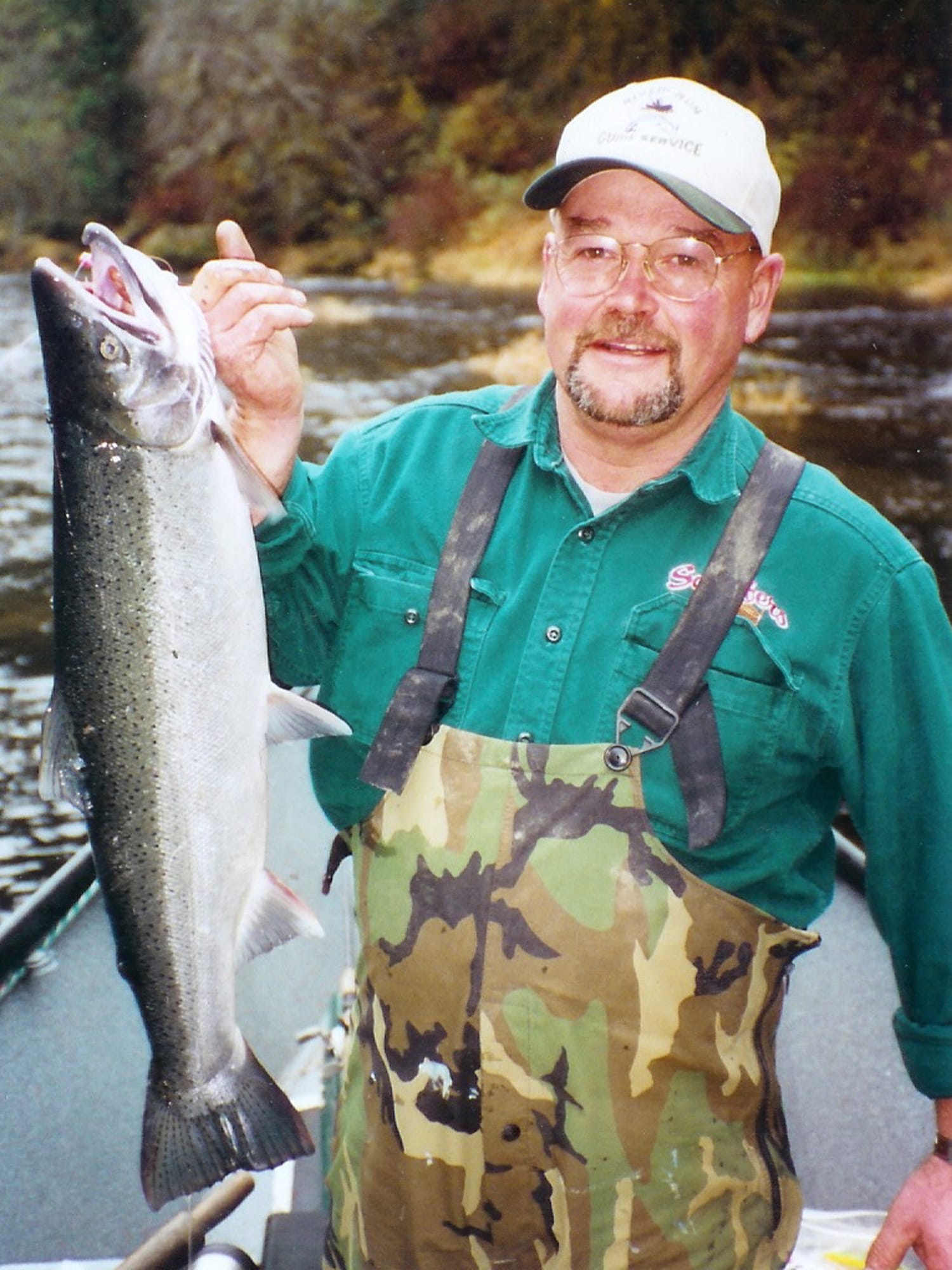 Stan Steele holds a hatchery steelhead caught on the Alsea River outside Waldport, Ore.