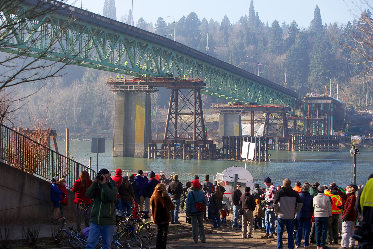 Spectators look on as the Sellwood Bridge is moved Jan 19, 2013, to temporary supports so a new bridge could be built across the Willamette River in Portland.