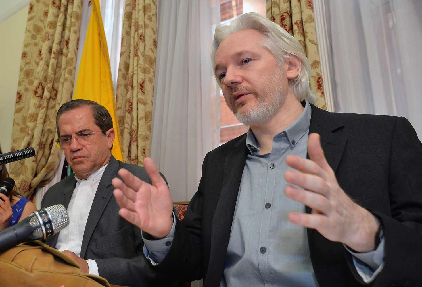 Ecuador's Foreign Minister Ricardo Patino, left, and WikiLeaks founder Julian Assange speak during a press conference inside the Ecuadorian Embassy in London, where he confirmed he &quot;will be leaving the embassy soon&quot;, Monday Aug. 18, 2014.  The Australian Assange fled to the Ecuadorian Embassy in 2012 to escape extradition to Sweden, where he is wanted over allegations of sex crimes.