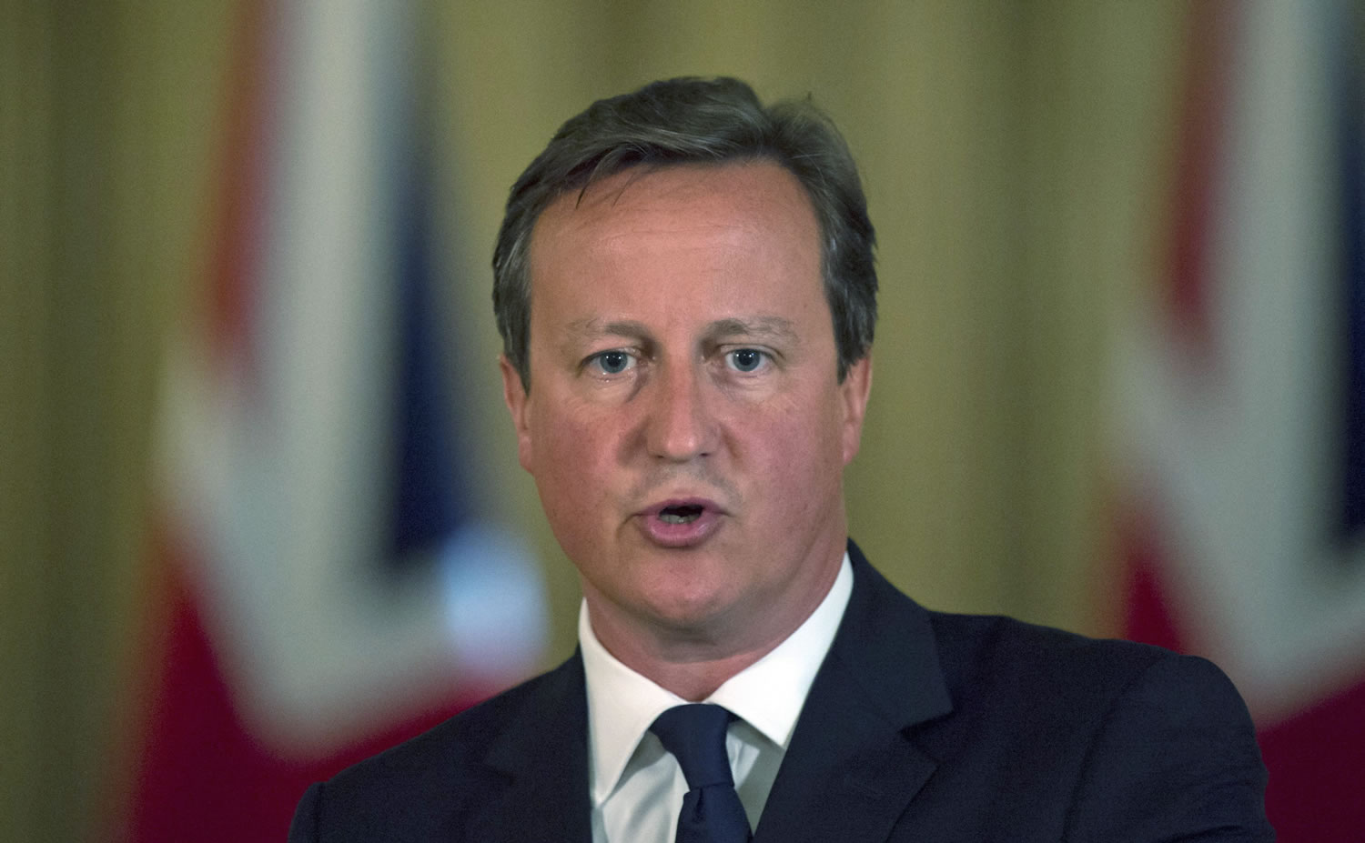 British Prime Minister David Cameron delivers a report to the media in Downing Street, London, on Friday Aug. 29.