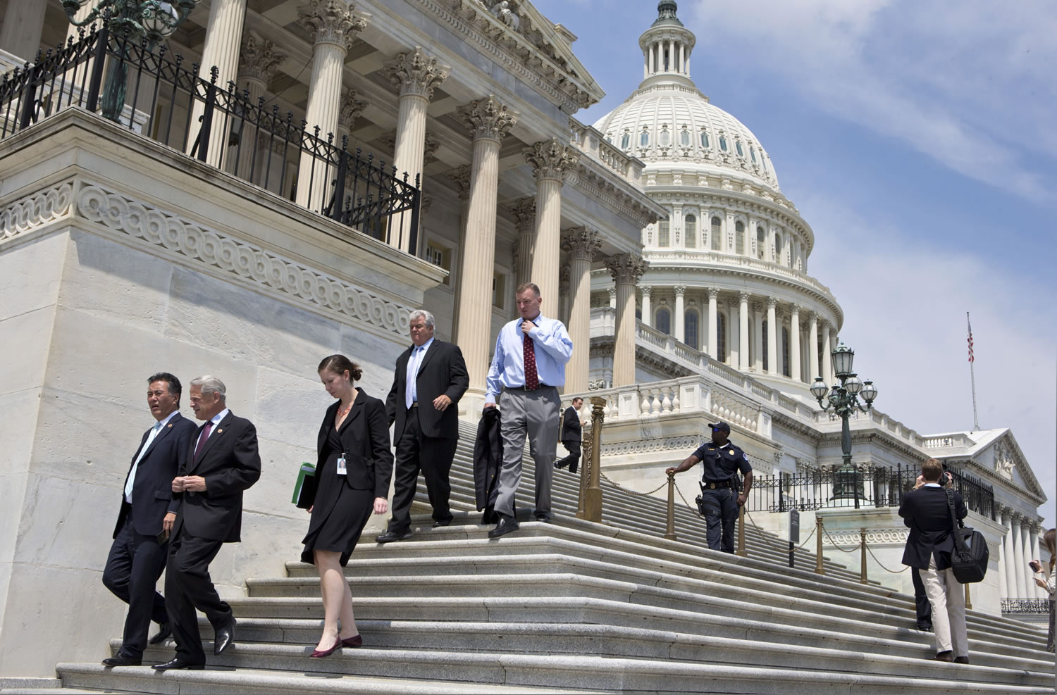 Members of Congress walk down the steps of the House of Representatives on Capitol Hill on Aug.