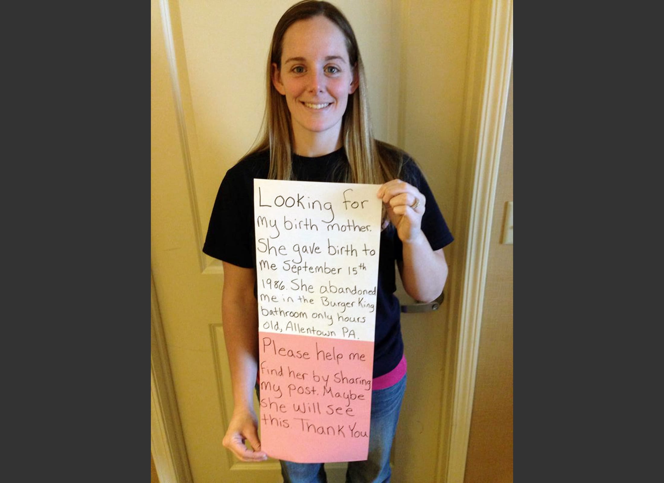 Katheryn Deprill is shown in a March 2 photo that she posted on Facebook holding a sign that says she is seeking her birth mother. Deprill was abandoned in the bathroom of a Burger King restaurant in Allentown, Pa., when she was a few hours old. Deprill tells The Associated Press that she met her biological mother for the first time Monday in an attorney's office.