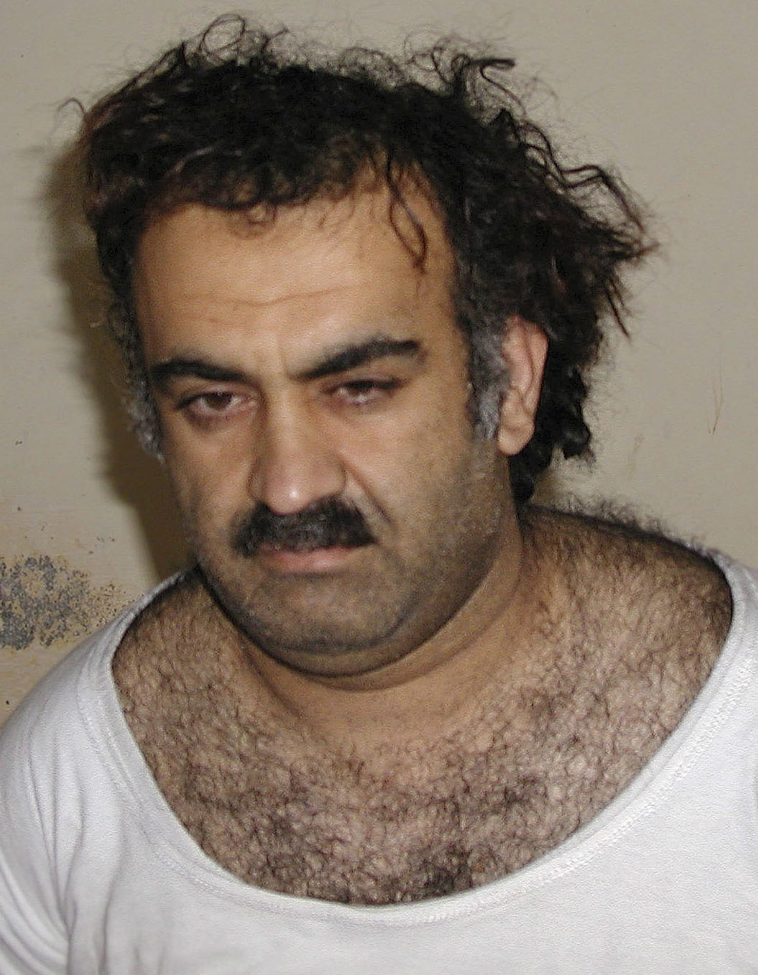 Khalid Sheikh Mohammed in March 2003, shortly after his capture during a raid in Pakistan. When CIA interrogators were torturing 9/11 mastermind Khalid Sheikh Mohammed at a secret prison in Poland in March 2003, a top CIA analyst asked the interrogators to show Mohammed a photograph of an alleged terrorist named Majid Khan. The interrogators slapped Mohammed, denied him sleep, rehydrated him through his rectum, threatened to kill his children and waterboarded him 183 times.