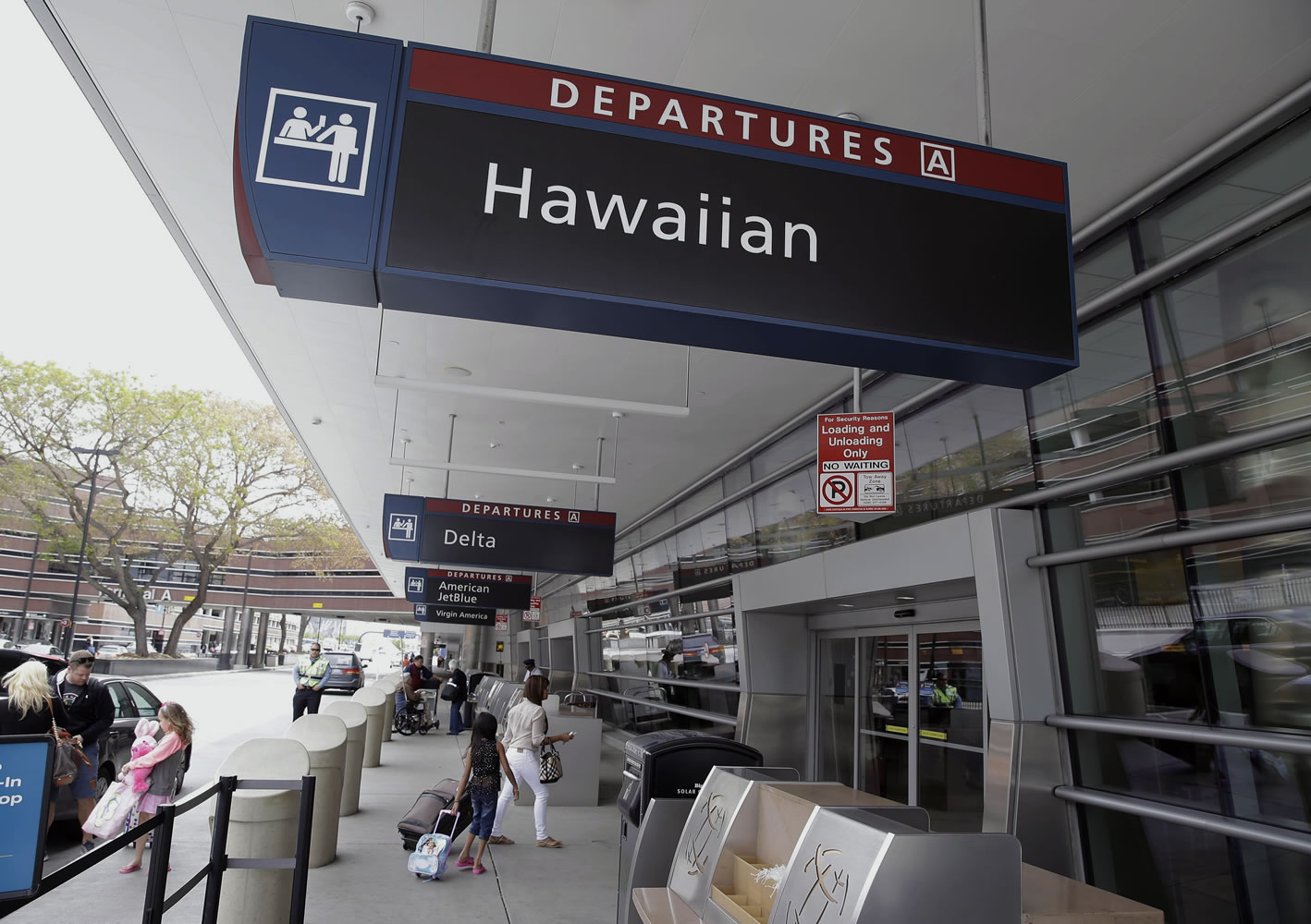 People make their way into Terminal A at Mineta San Jose International Airport near the Hawaiian Airlines gates Monday in San Jose, Calif.